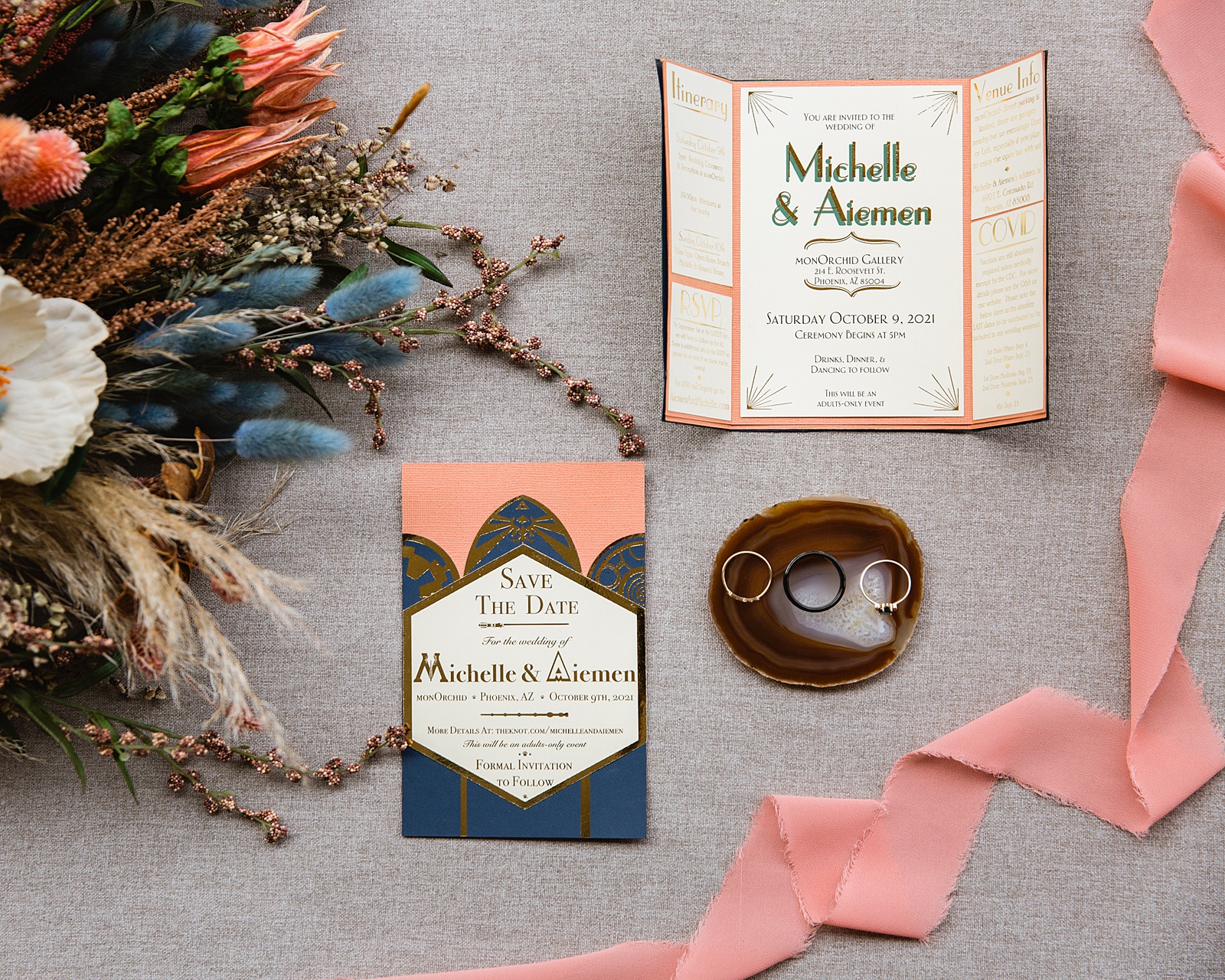 Art deco inspired peach and navy wedding invitations with a dried floral wedding bouquet and rings by Phoenix wedding photographer PMA Photography.