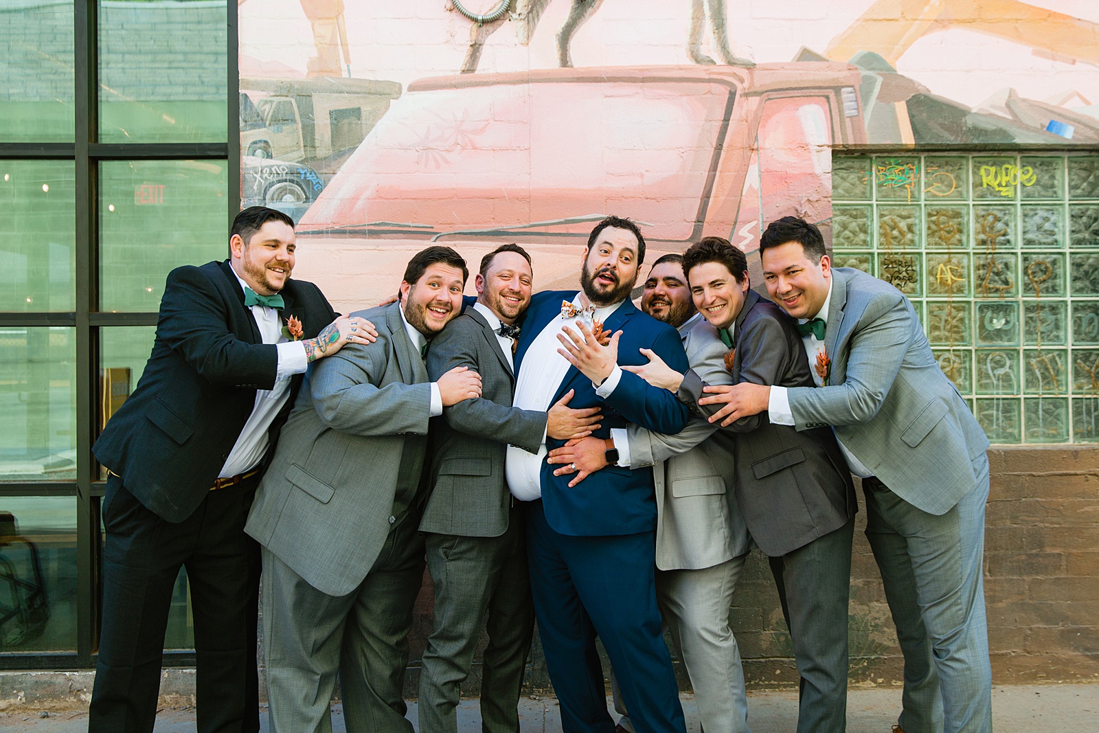 Groom and groomsmen laughing together at MonOrchid wedding by Phoenix wedding photographer PMA Photography.