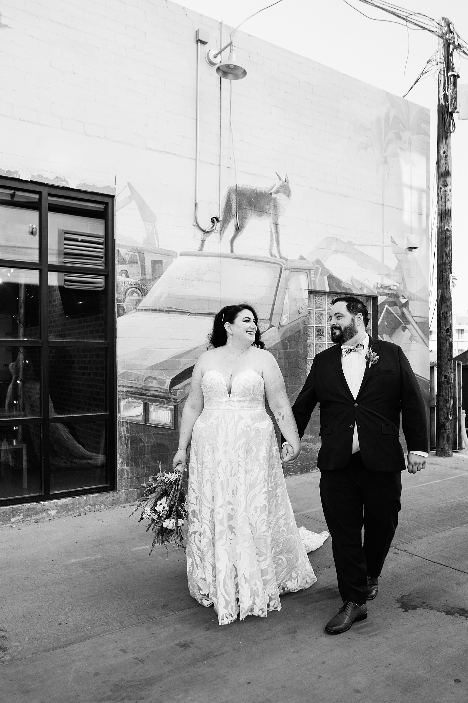 Bride and Groom walking together during their MonOrchid wedding by Arizona wedding photographer PMA Photography.