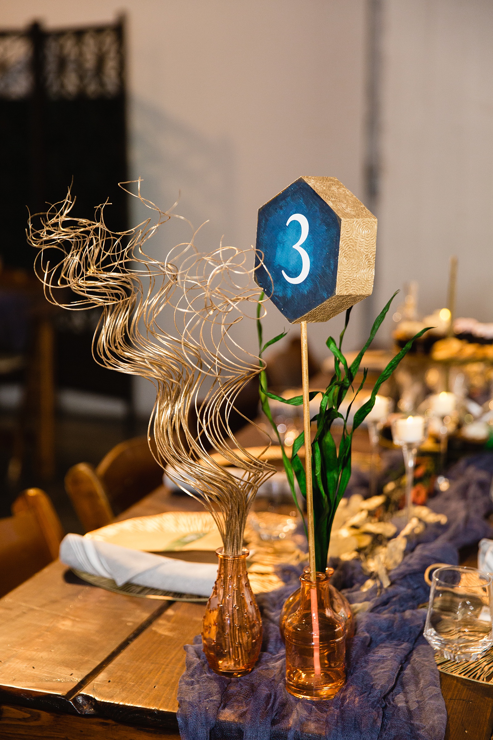 Gold and blue art deco inspired table number and reception decorations at MonOrchid wedding reception by Phoenix wedding photographer PMA Photography.