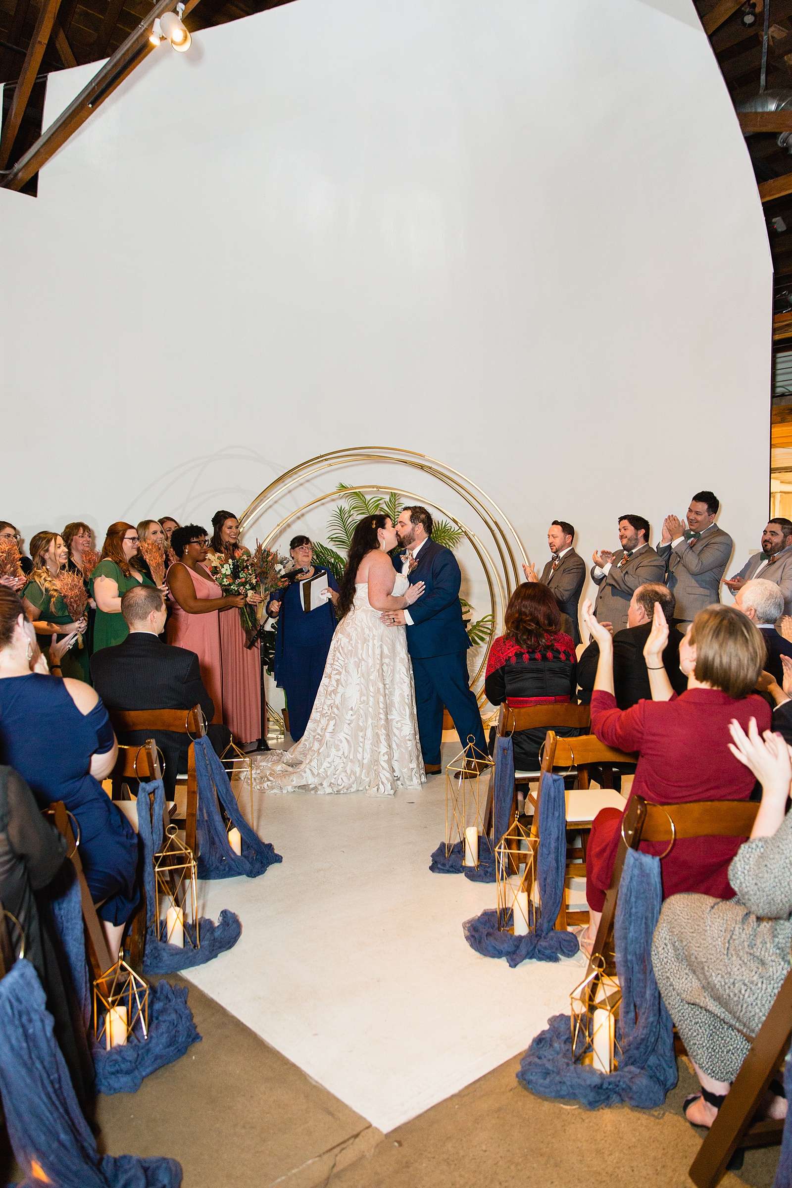 Bride and Groom share their first kiss during their wedding ceremony at MonOrchid by Arizona wedding photographer PMA Photography.