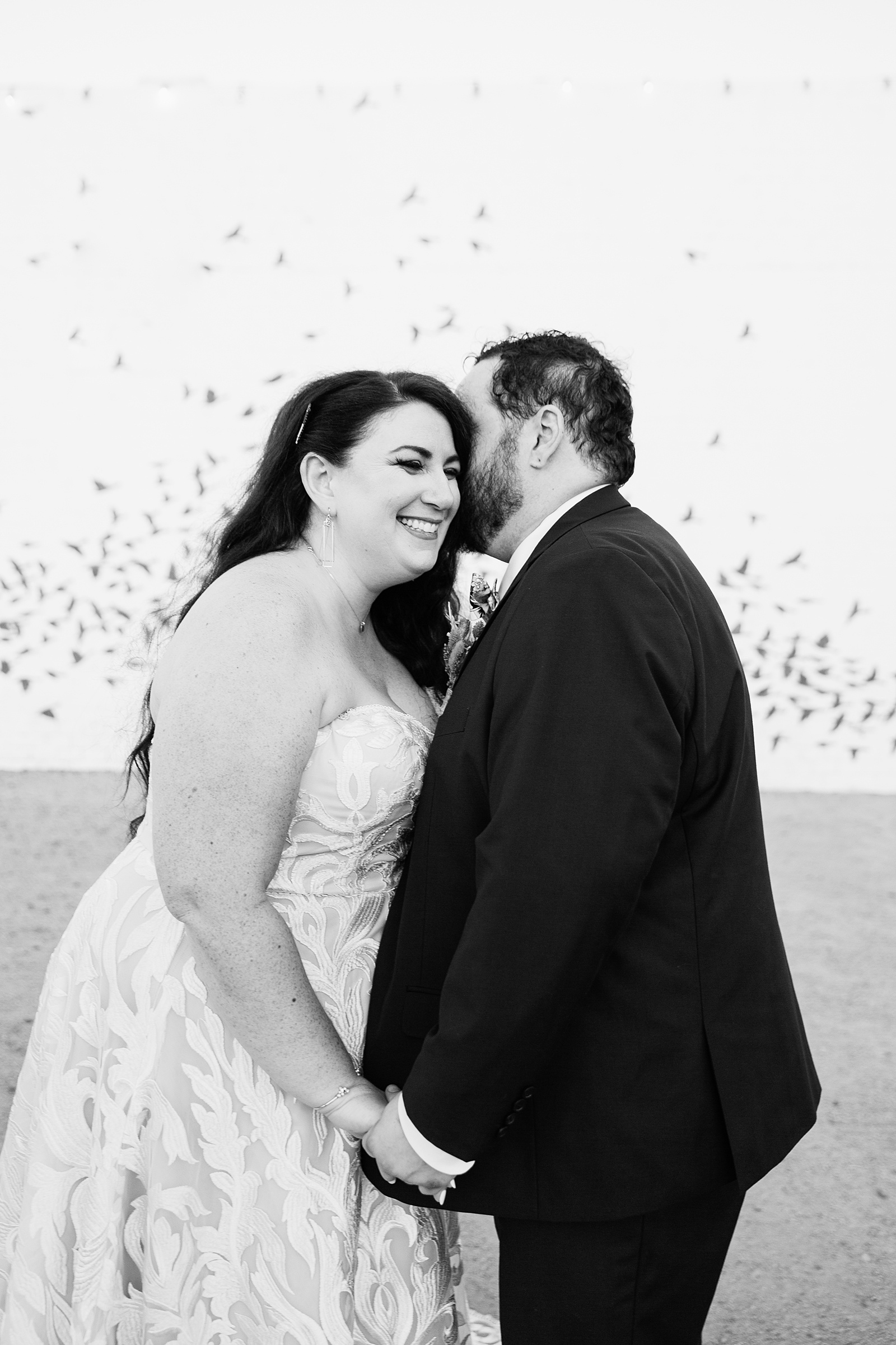 Bride and Groom laughing together during their MonOrchid wedding by Arizona wedding photographer PMA Photography.