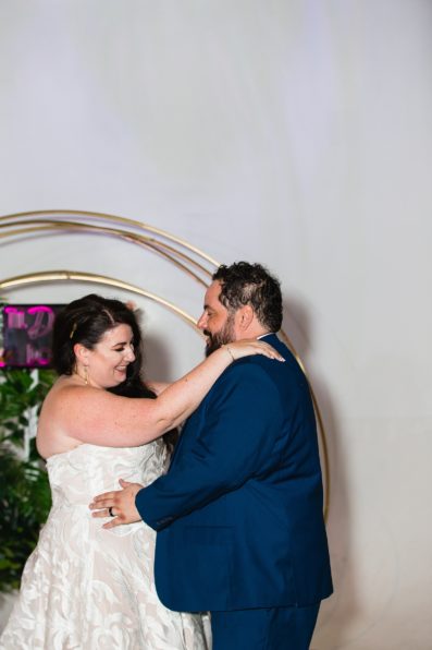 Bride and Groom sharing first dance at their MonOrchid wedding reception by Arizona wedding photographer PMA Photography.