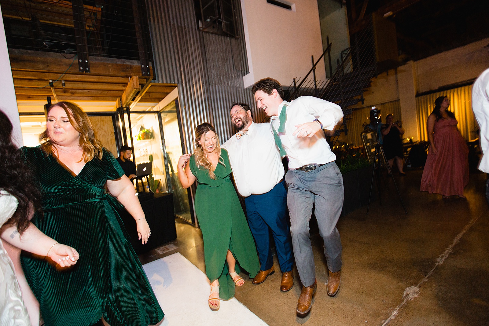 Groom dancing with guests at MonOrchid wedding reception by Phoenix wedding photographer PMA Photography