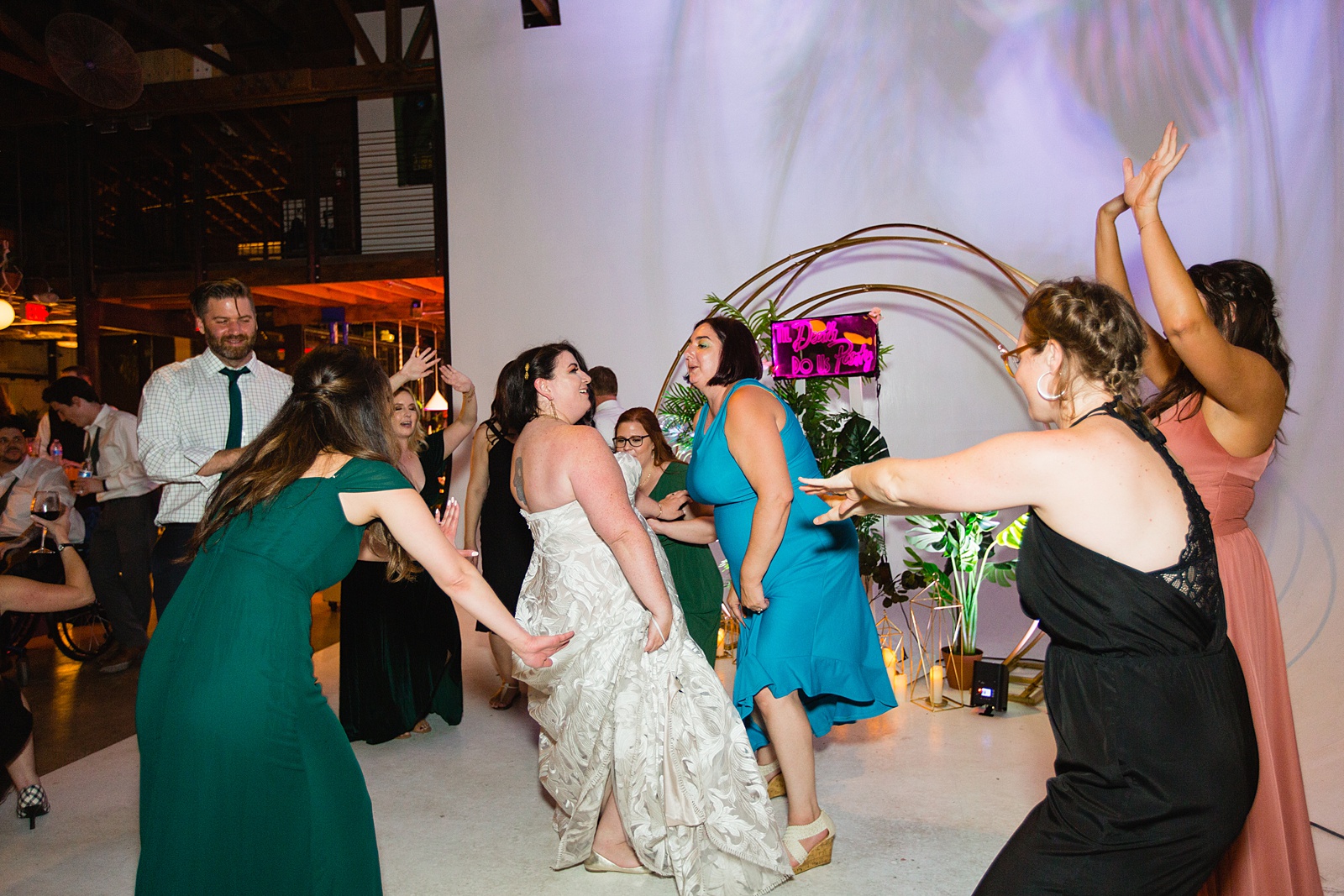 Bride dancing with guests at MonOrchid wedding reception by Phoenix wedding photographer PMA Photography