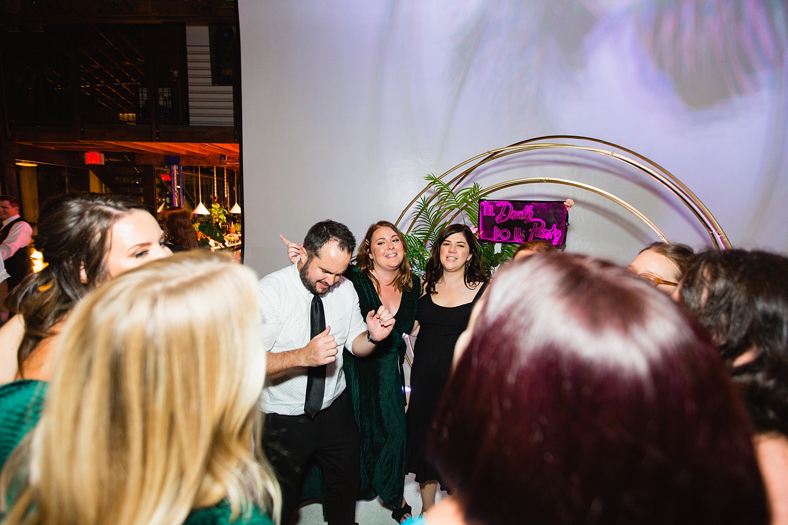 Guests dancing together at a MonOrchid wedding reception by Phoenix wedding photographer PMA Photography