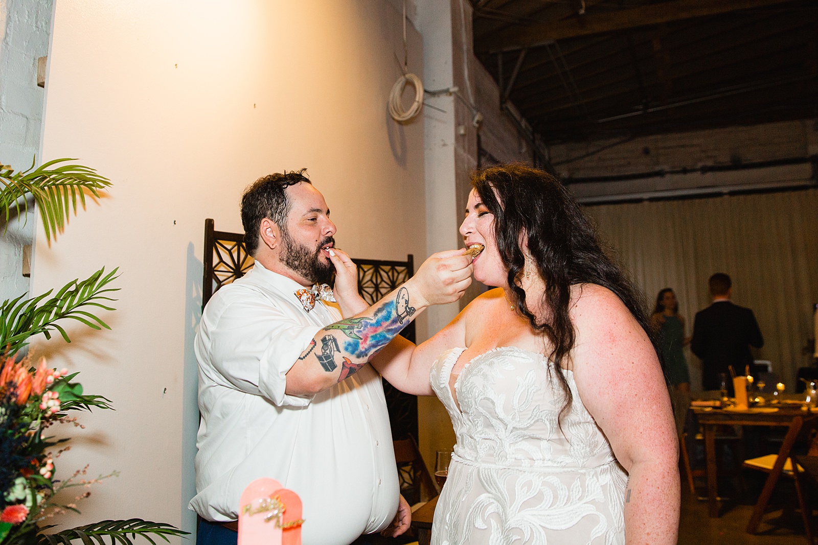 Bride and Groom cutting their wedding cake at their MonOrchid wedding reception by Arizona wedding photographer PMA Photography.