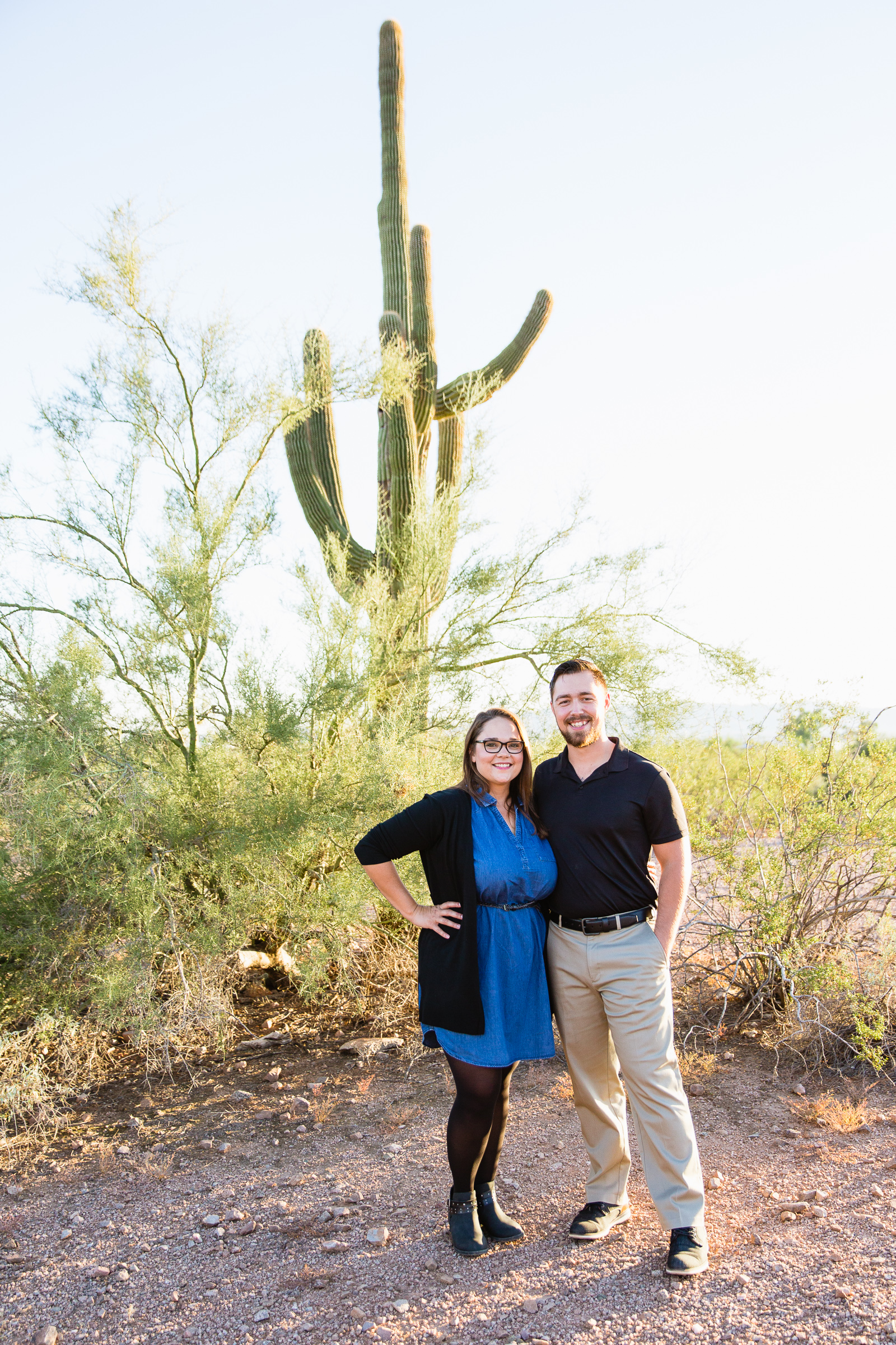 Couple pose during their Phoenix engagement session by Arizona wedding photographer PMA Photography.