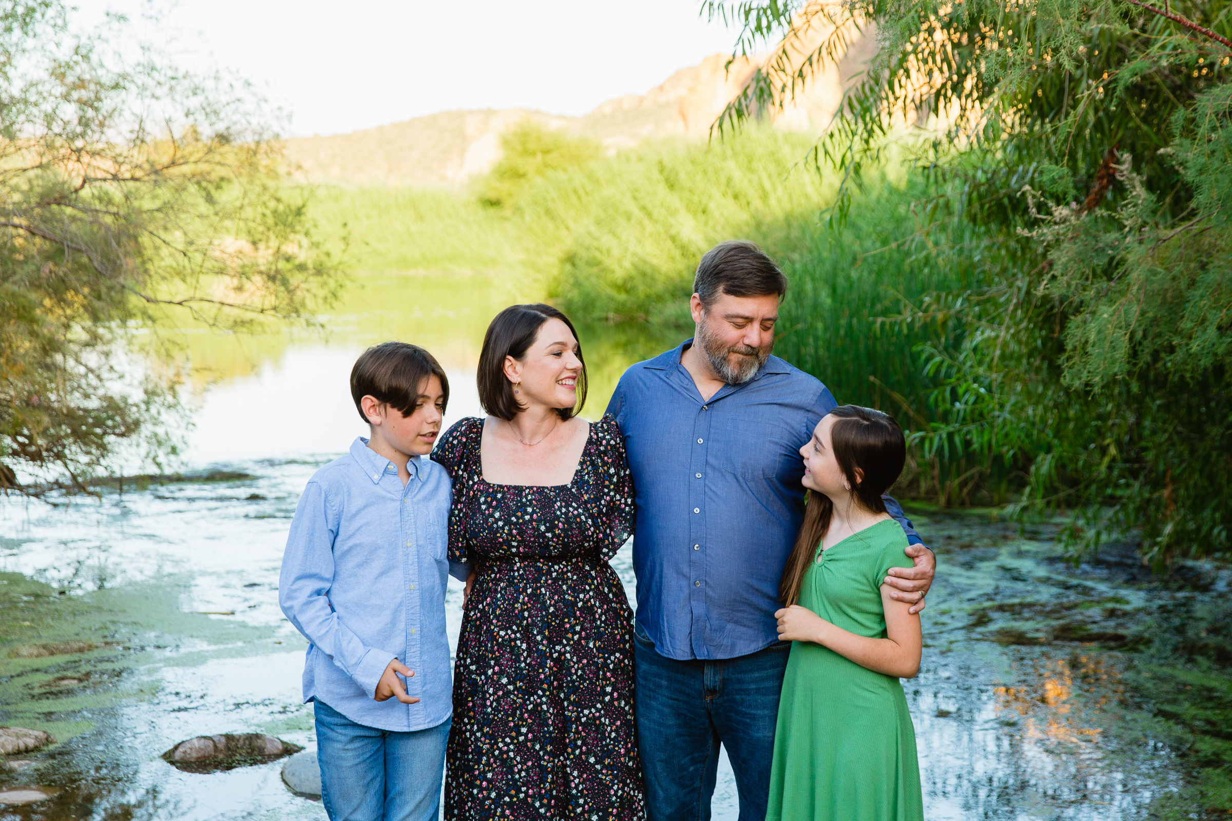 Family look at each other during their Salt River family session by Phoenix family photographer PMA Photography.