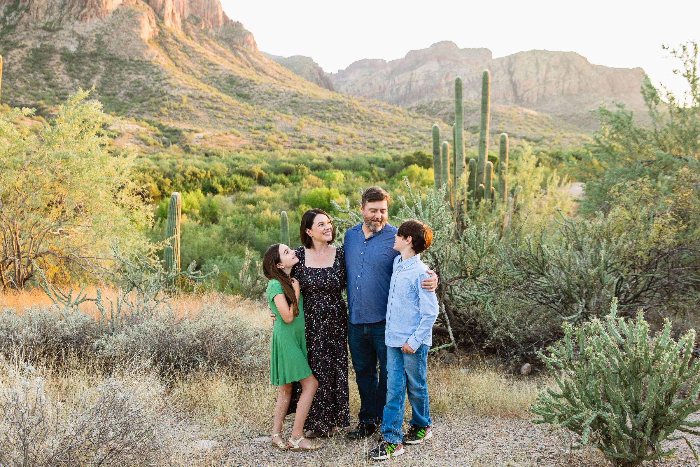 Family look at each other during their Salt River family session by Phoenix family photographer PMA Photography.
