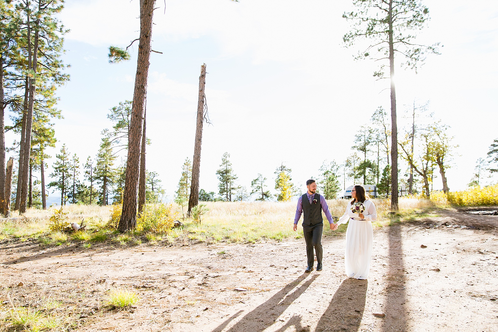 Bride and Groom walking together during their Mogollon Rim elopement by Arizona elopement photographer PMA Photography.