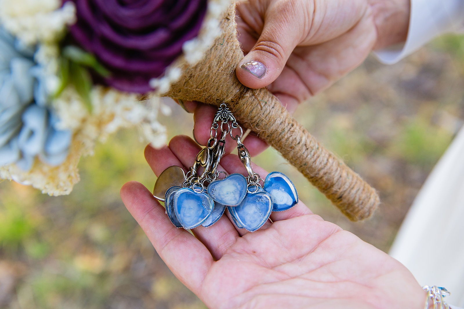 Charms of loved ones who have passed on a bride's bouquet by PMA Photography.