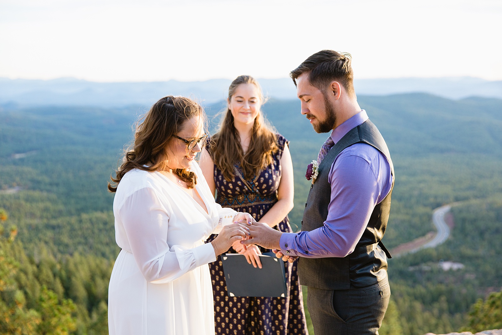 Bride and Groom exchange rings during their wedding ceremony at Mogollon Rim by Arizona elopement photographer PMA Photography.
