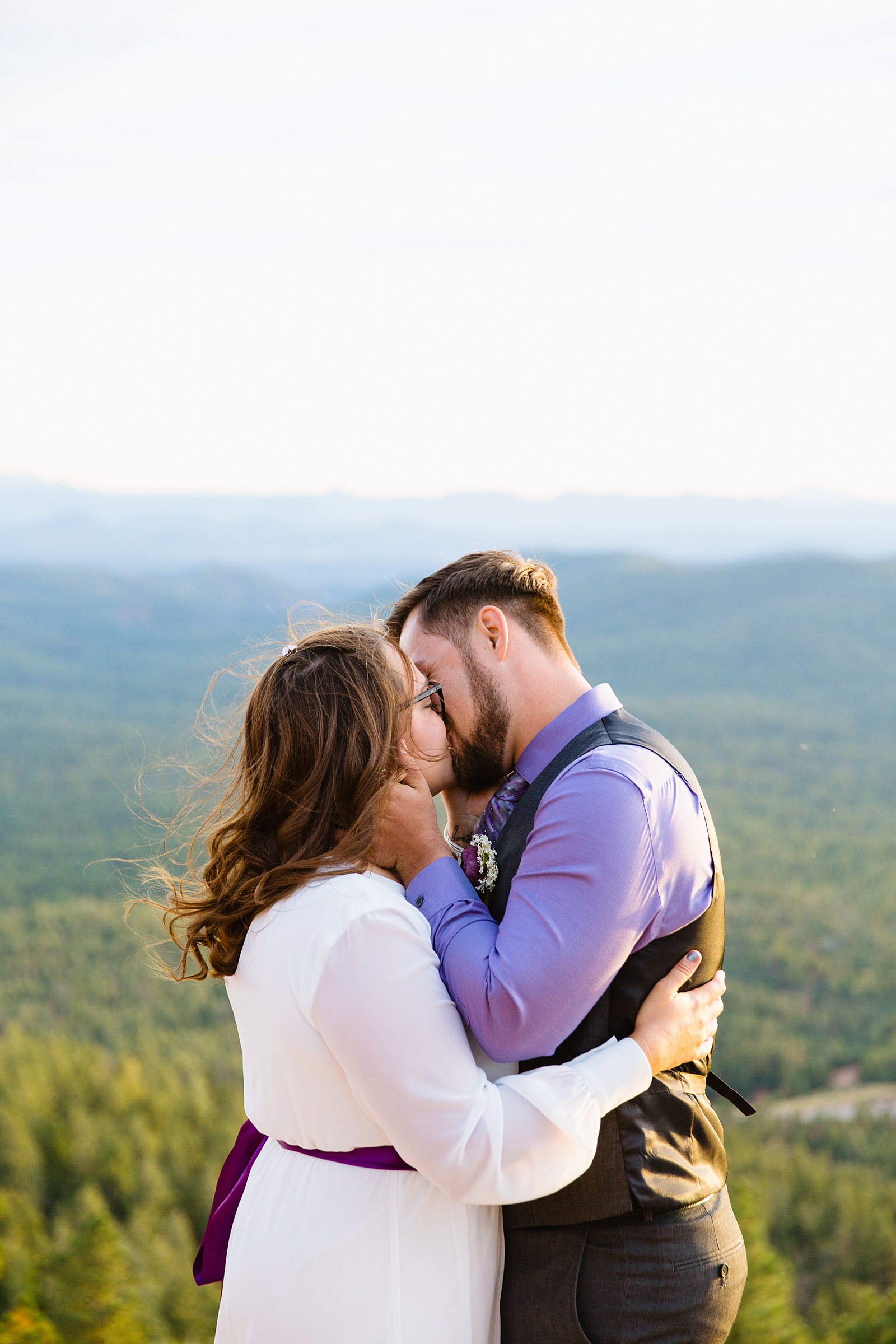 Bride and Groom share their first kiss during their wedding ceremony at Mogollon Rim by Arizona elopement photographer PMA Photography.