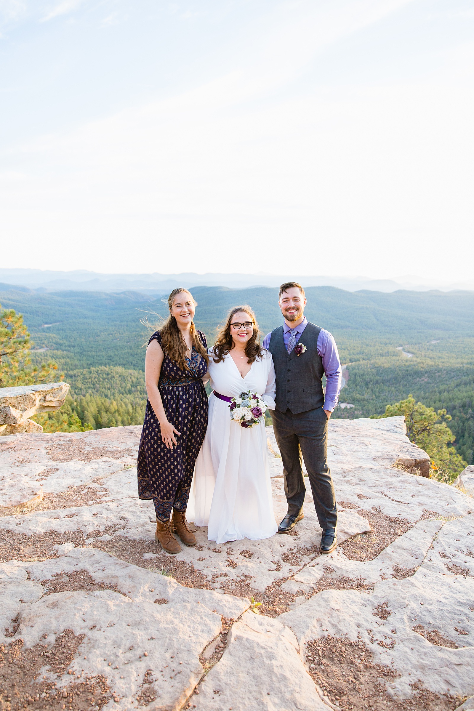 Bride and groom pose with their friend and officiant of their elopement on the Mogollon Rim by Arizona wedding photographer PMA Photography.
