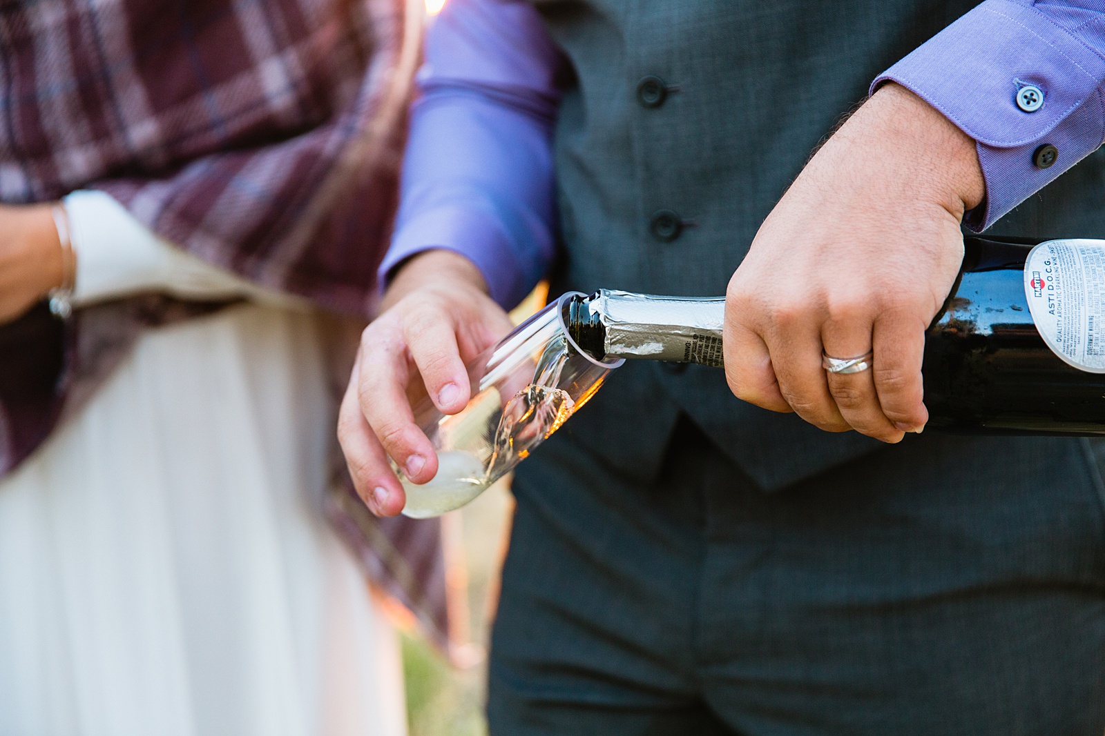 Bride and groom popping champagne to celebrate their Mogollon Rim elopement by Payson elopement photographer PMA Photography.
