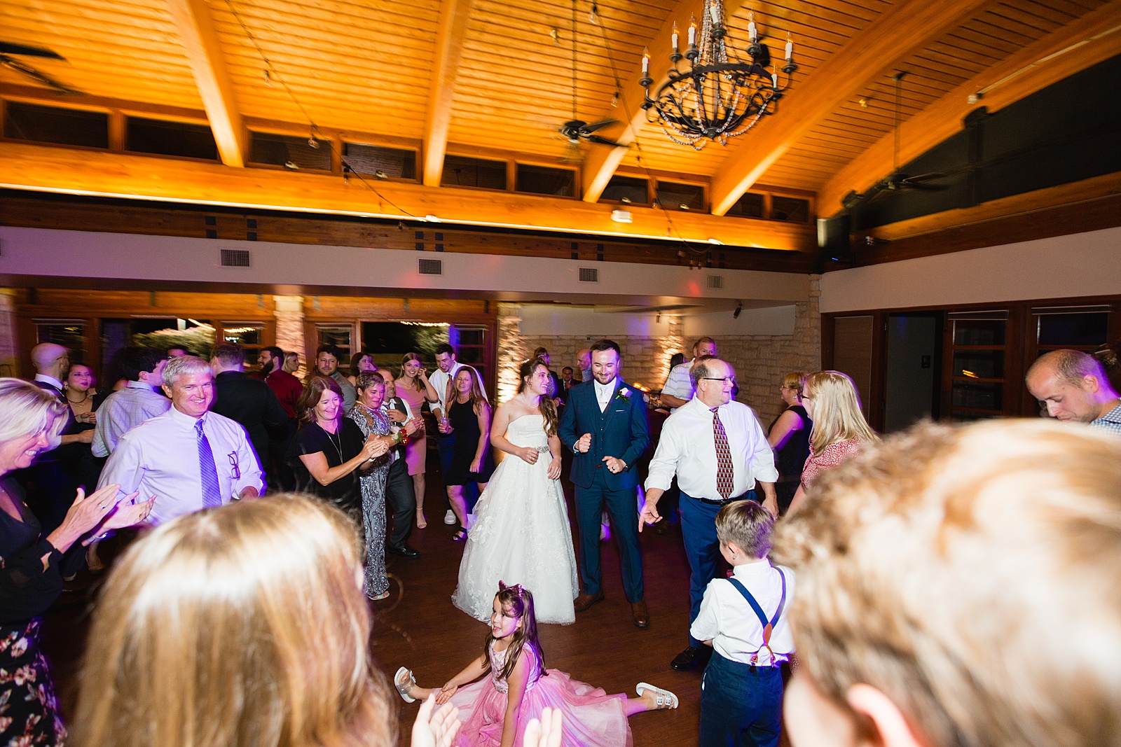 Bride and Groom dancing with guests at their Ocotillo Oasis wedding reception by Arizona wedding photographer PMA Photography