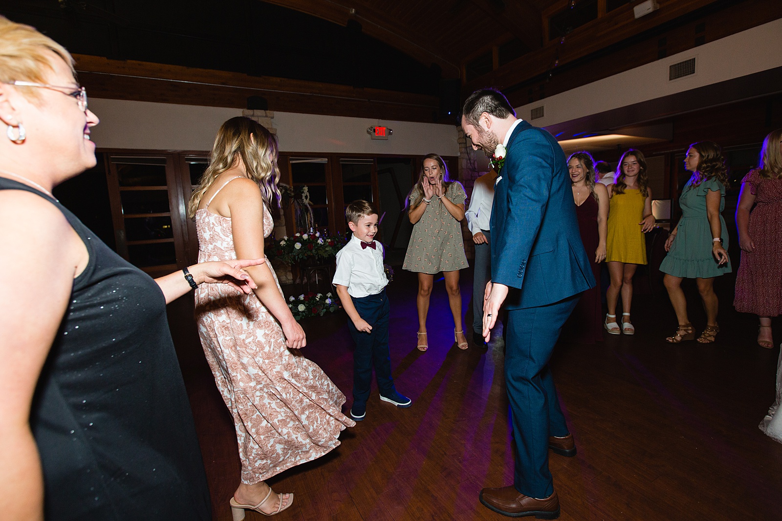 Groom dancing with guests at their Ocotillo Oasis wedding reception by Arizona wedding photographer PMA Photography