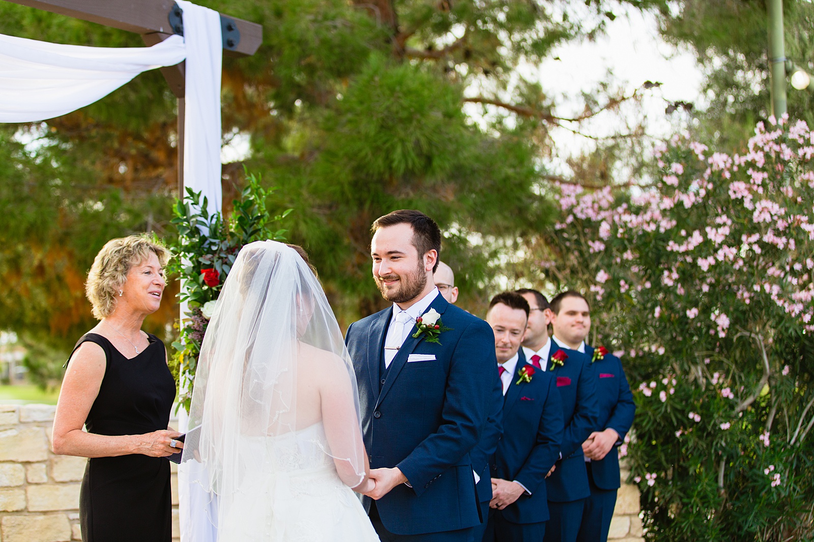 Groom looking at his bride during their wedding ceremony at Ocotillo Oasis by Phoenix wedding photographer PMA Photography.