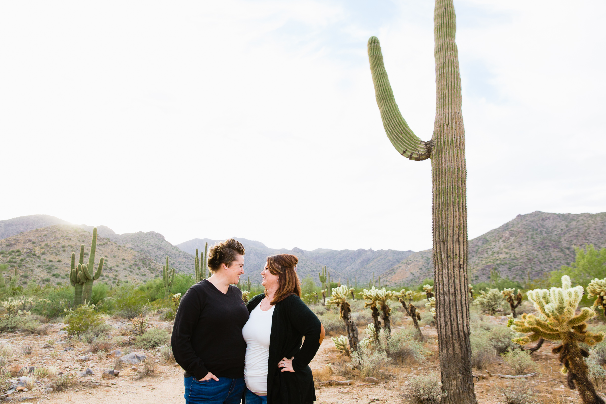 Couple look at each other during their Waddell anniversary session by Arizona wedding photographer PMA Photography.