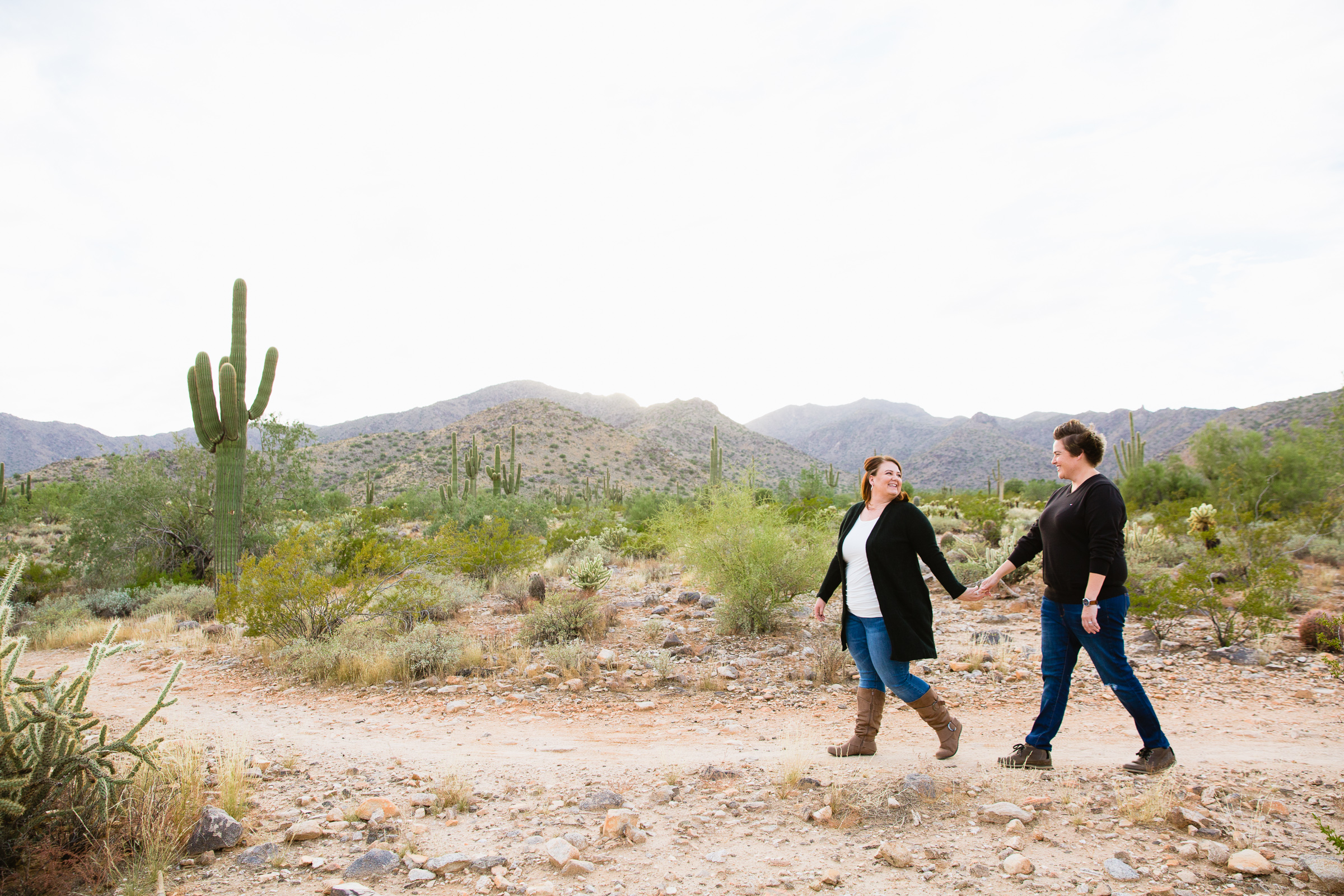Couple walking together during their White Tanks anniversary session by Waddell engagement photographer PMA Photography.