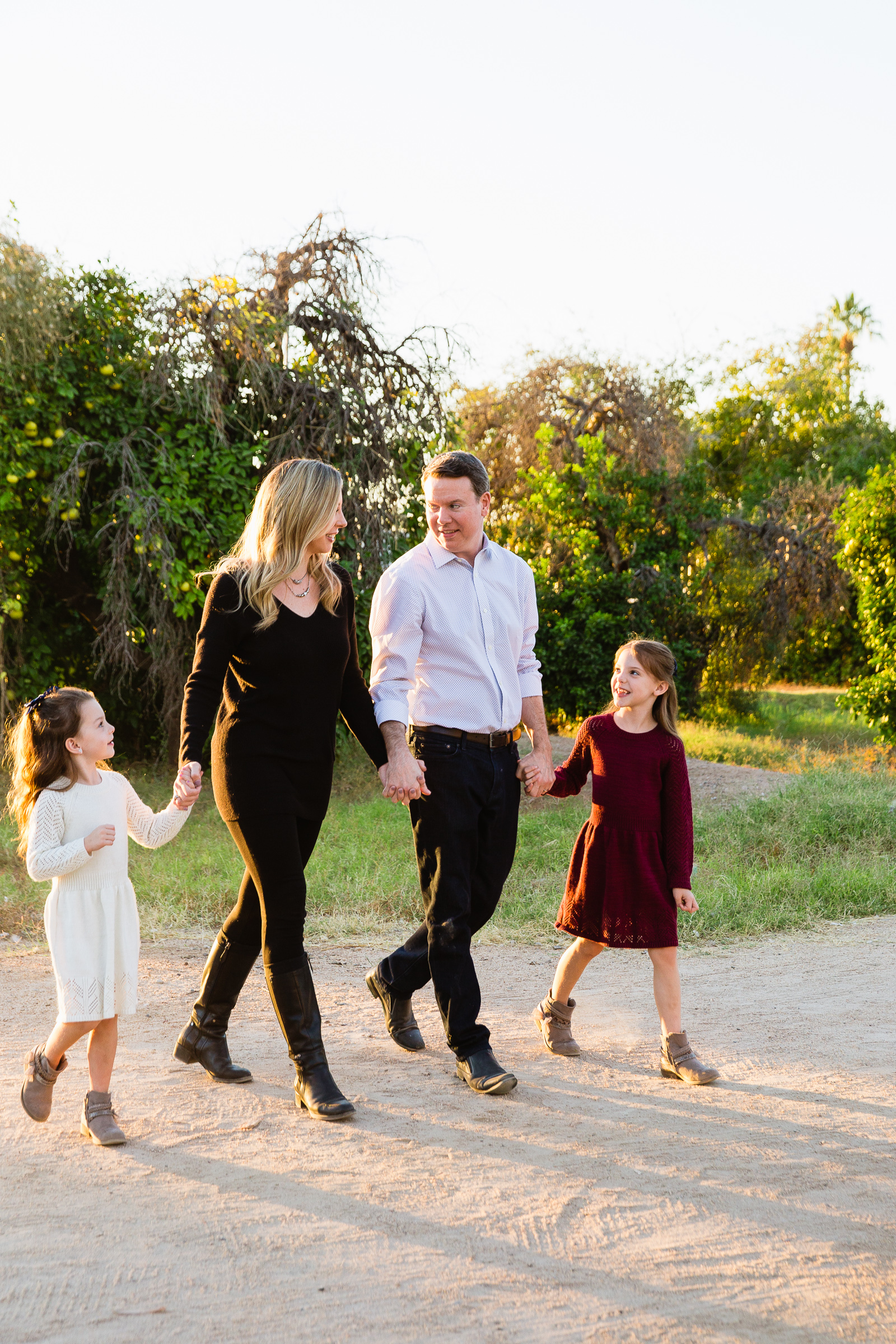 Family walking together during their Glendale family session by Arizona family photographer PMA Photography.