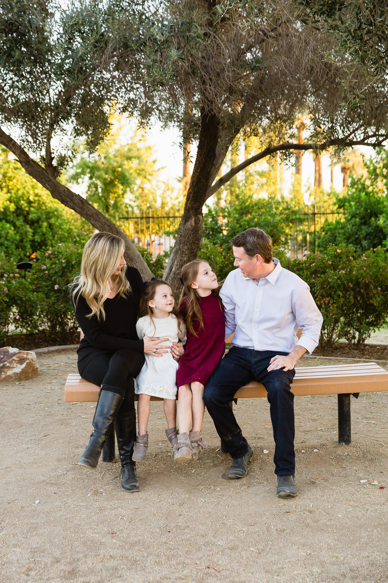 Family look at each other during their Glendale family session by Arizona family photographer PMA Photography.