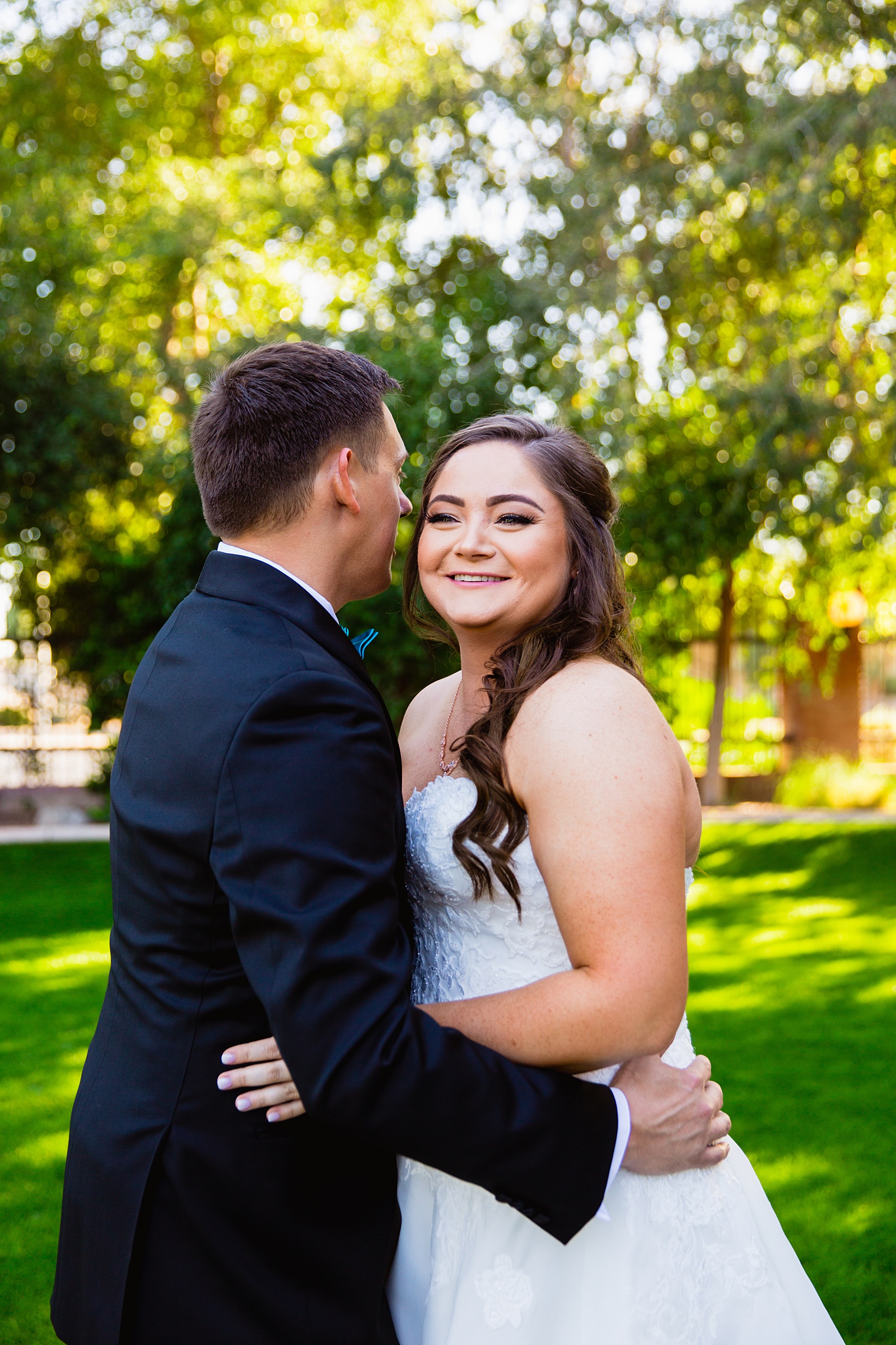 Bride and groom laughing together during their Stonebridge Manor wedding by Arizona wedding photographer PMA Photography.