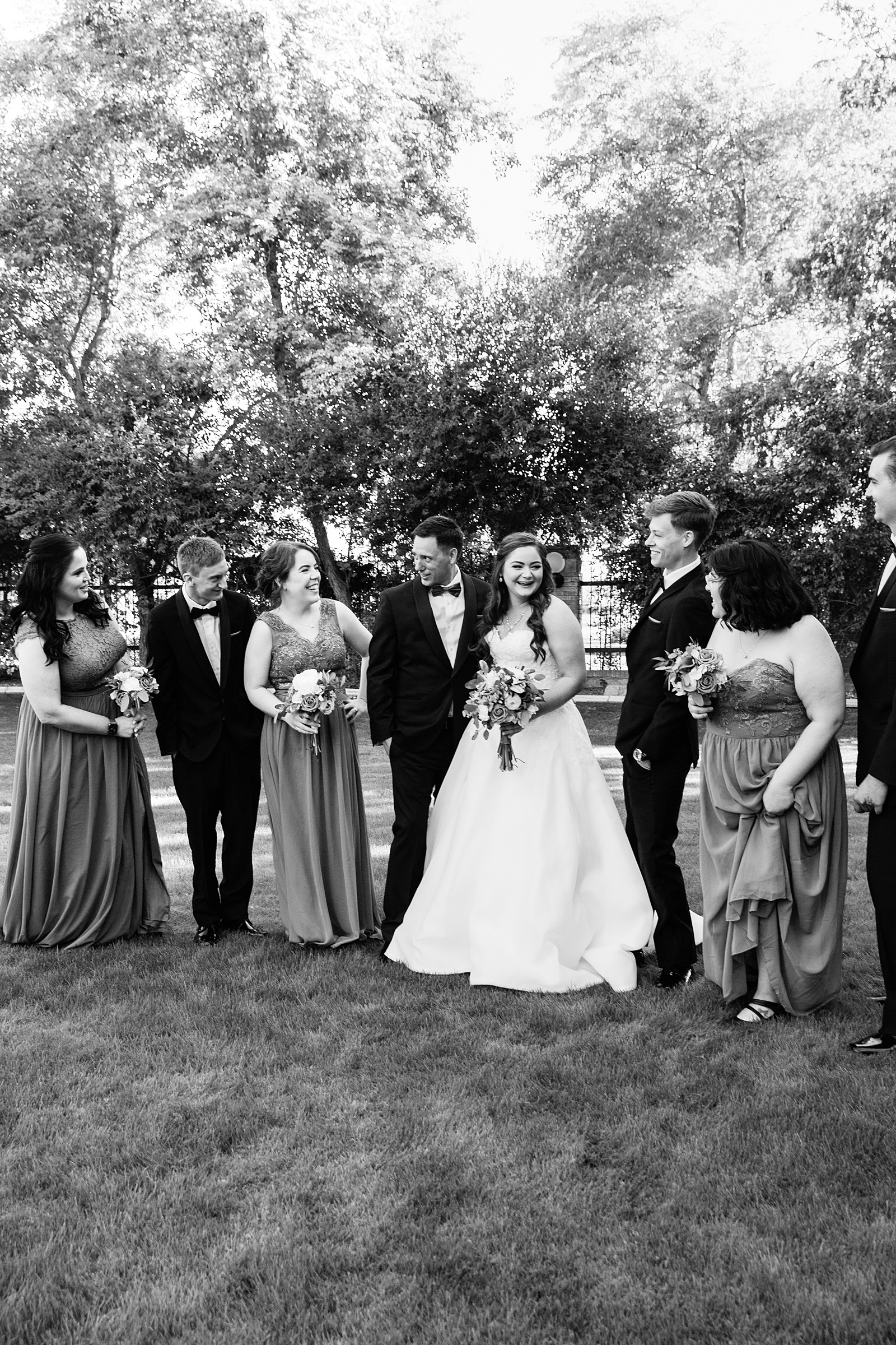 Bridal party laughing together at Stonebridge Manor wedding by Mesa wedding photographer PMA Photography.