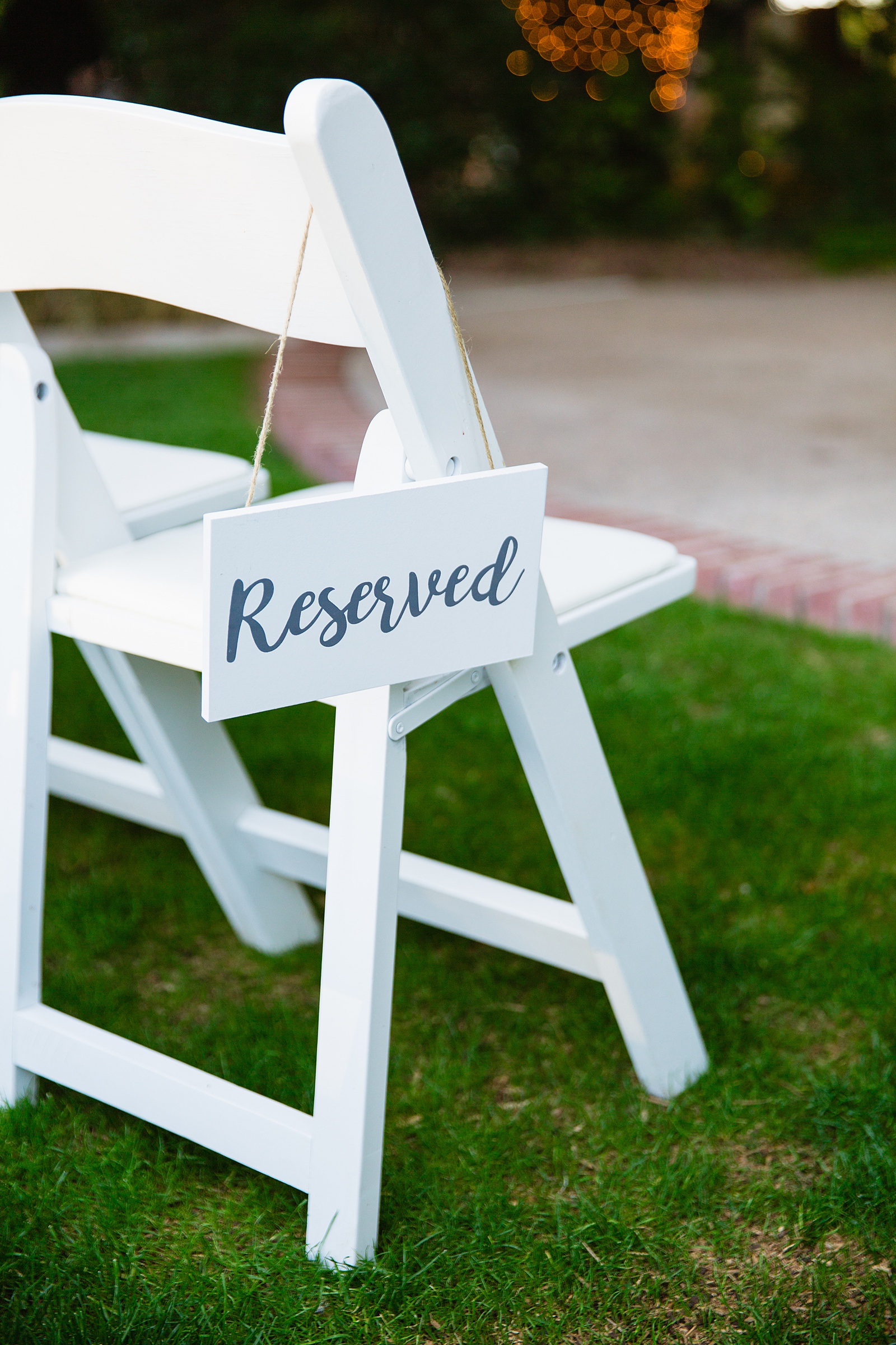 Simple white Reserved sign on chairs for a wedding ceremony by PMA Photography.