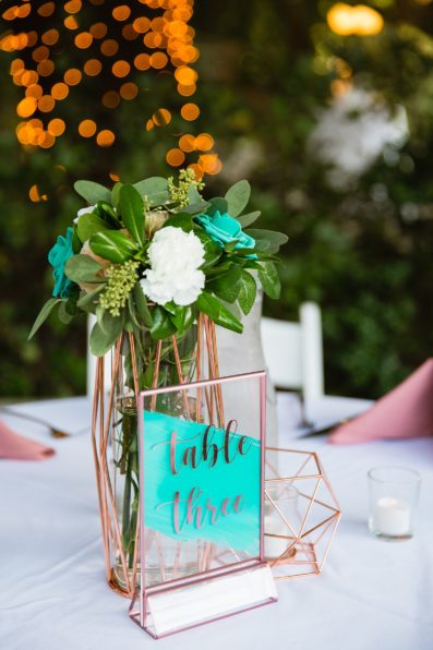 Rose gold and teal modern table centerpieces by PMA Photography.