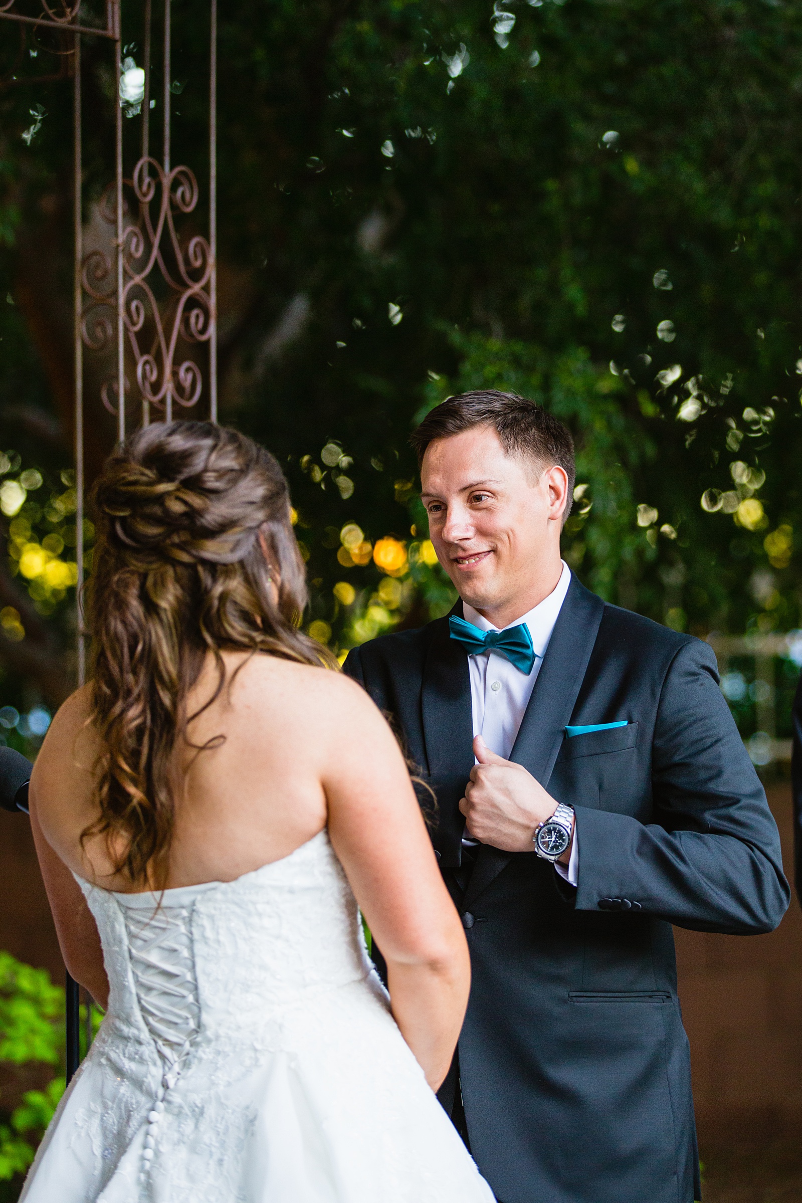 Groom looking at his bride during their wedding ceremony at Stonebridge Manor by Mesa wedding photographer PMA Photography.