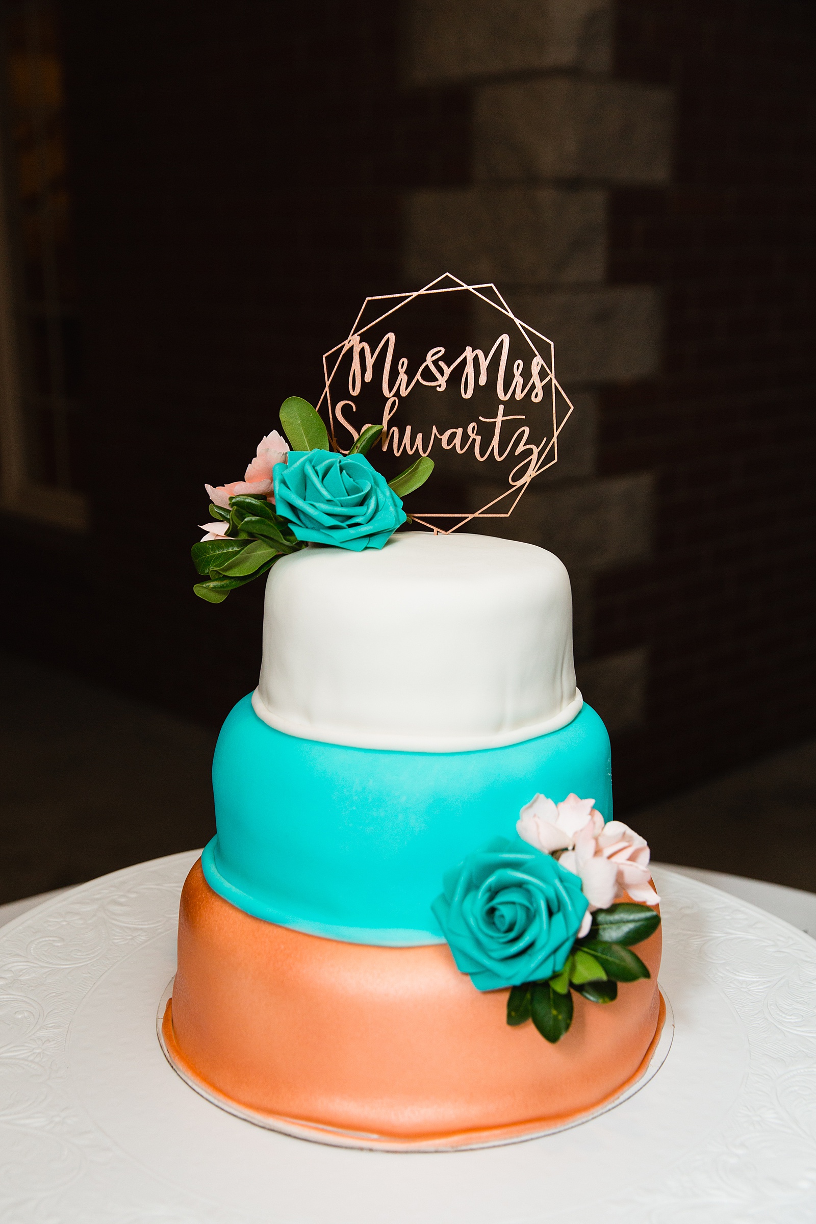 White, teal, and copper simple wedding cake by PMA Photography.