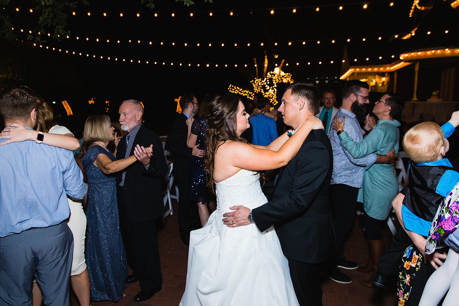 Bride and Groom dancing with guests at their Stonebridge Manor wedding reception by Arizona wedding photographer PMA Photography