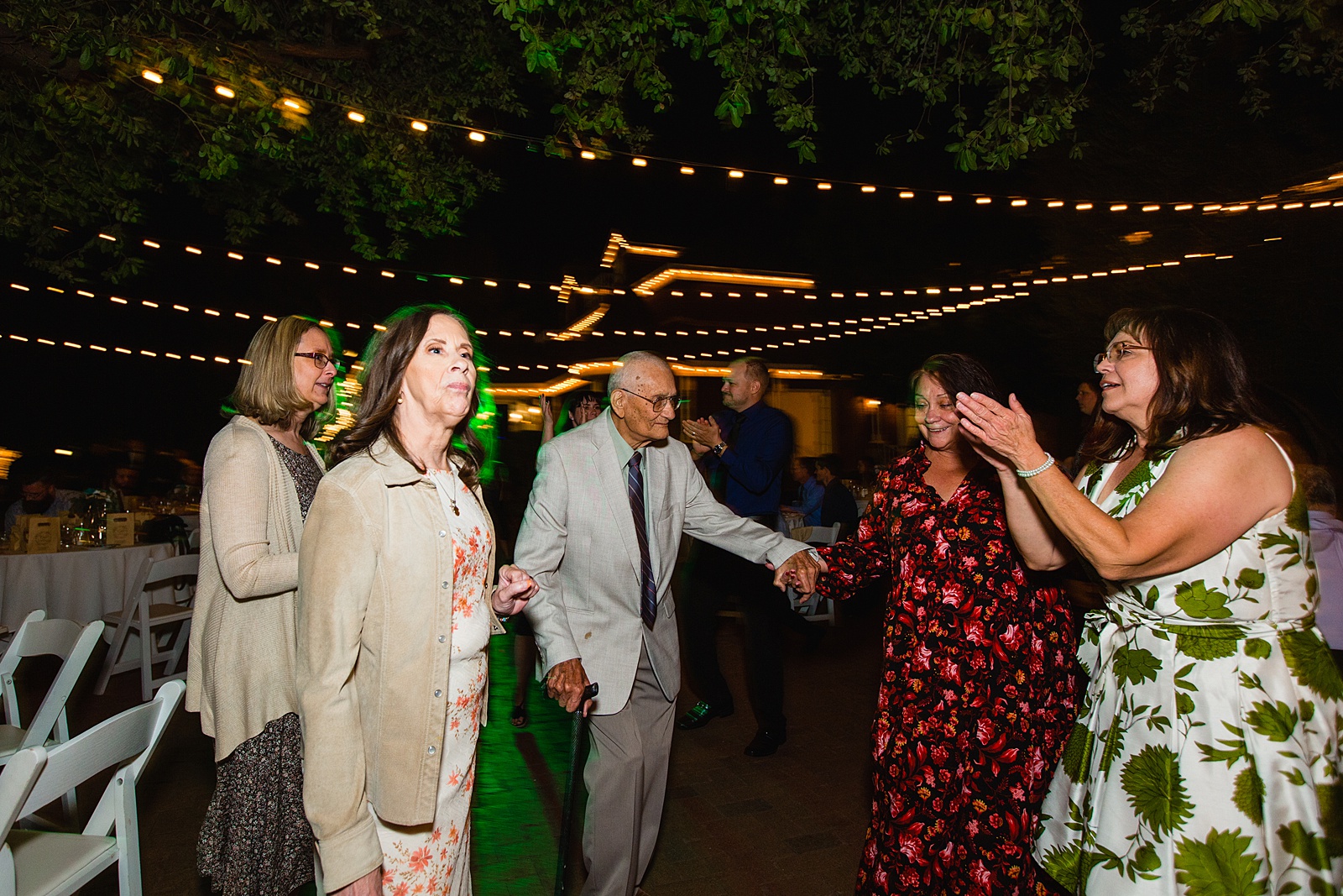 Guests dancing together at Stonebridge Manor wedding reception by Mesa wedding photographer PMA Photography