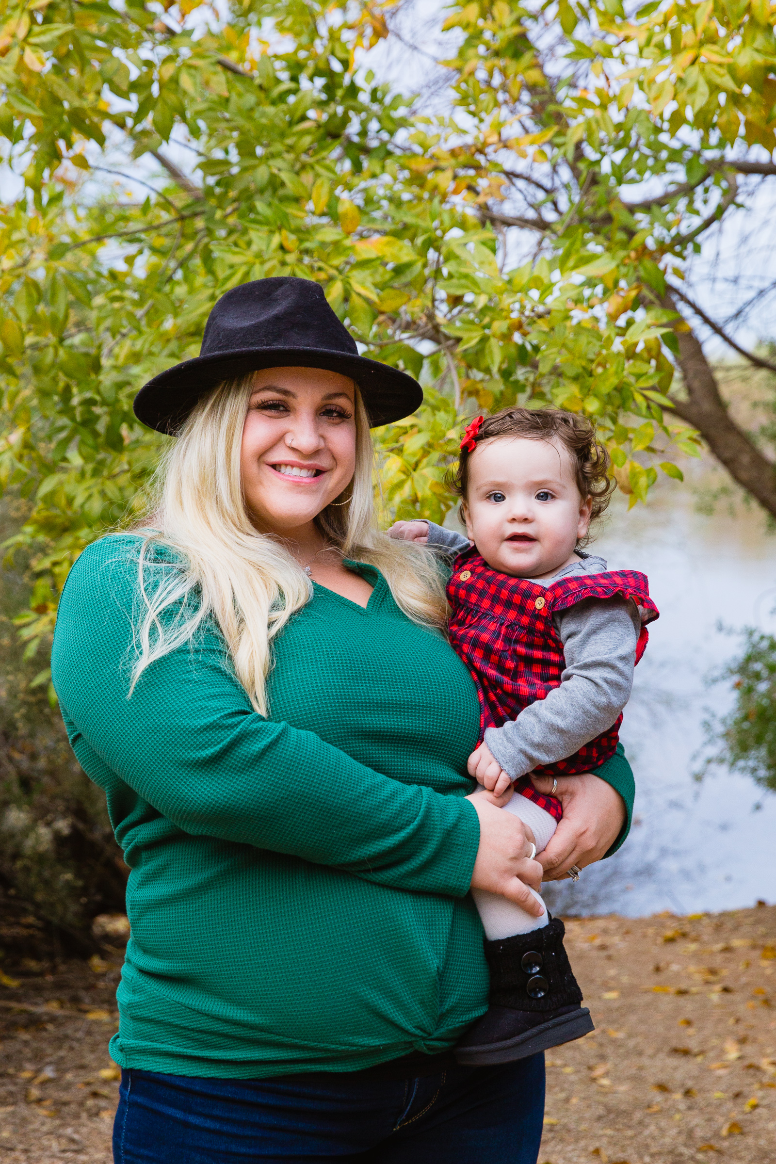 Pregnant mother poses with her child during their Riparian Preserve at Water Ranch family session by Gilbert family photographer PMA Photography.