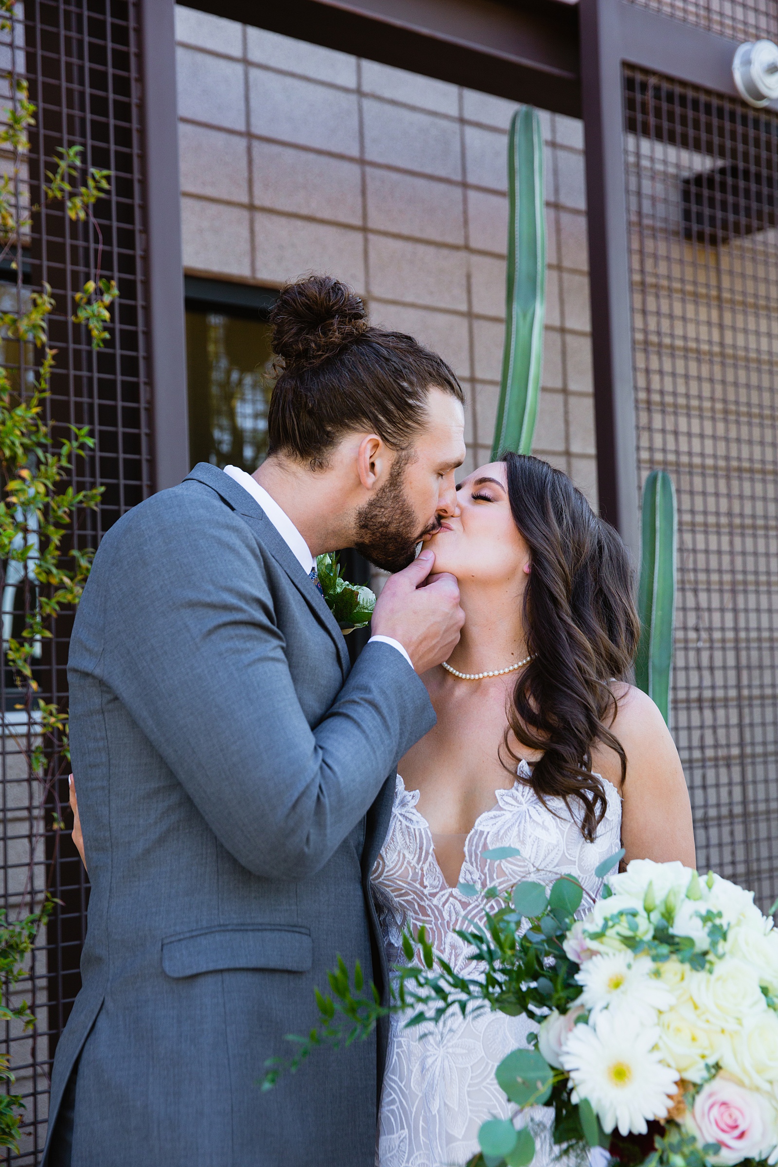 Bride and groom share a kiss during their Papago Events wedding by Arizona wedding photographer PMA Photography.
