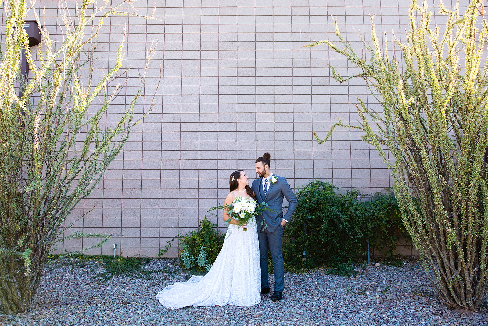 Bride and groom pose for their Papago Events wedding by Phoenix wedding photographer PMA Photography.