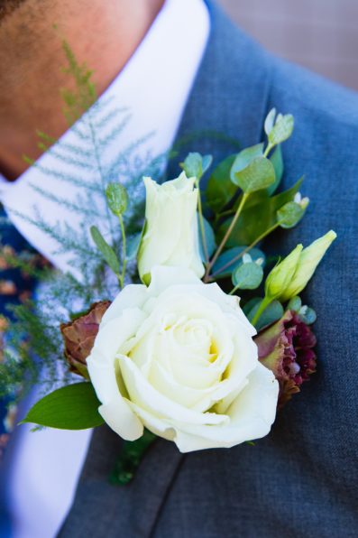 Groom's boho inspired cream and purple boutonniere by PMA Photography.