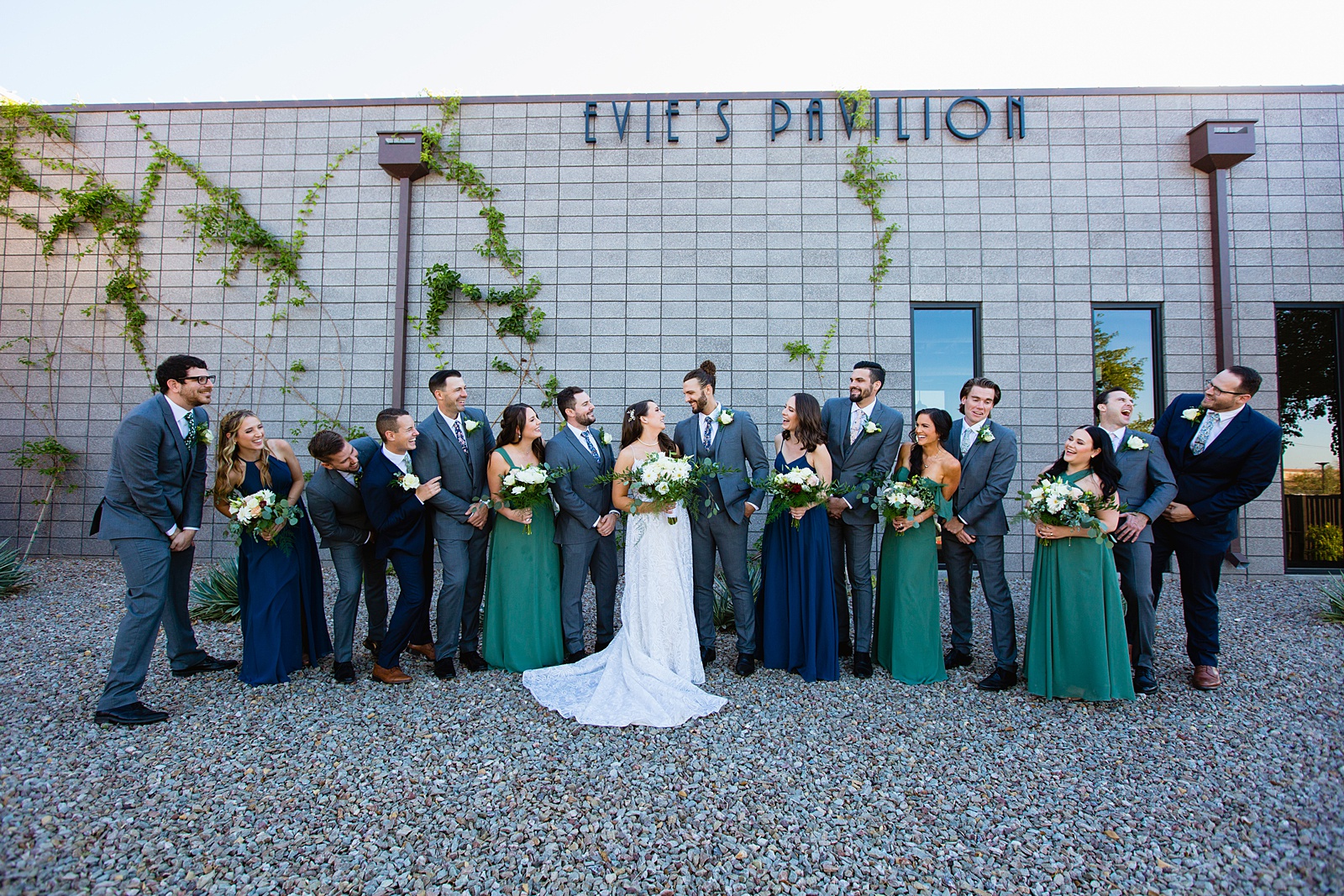 Mixed gender bridal party laughing together at Papago Events wedding by Phoenix wedding photographer PMA Photography.