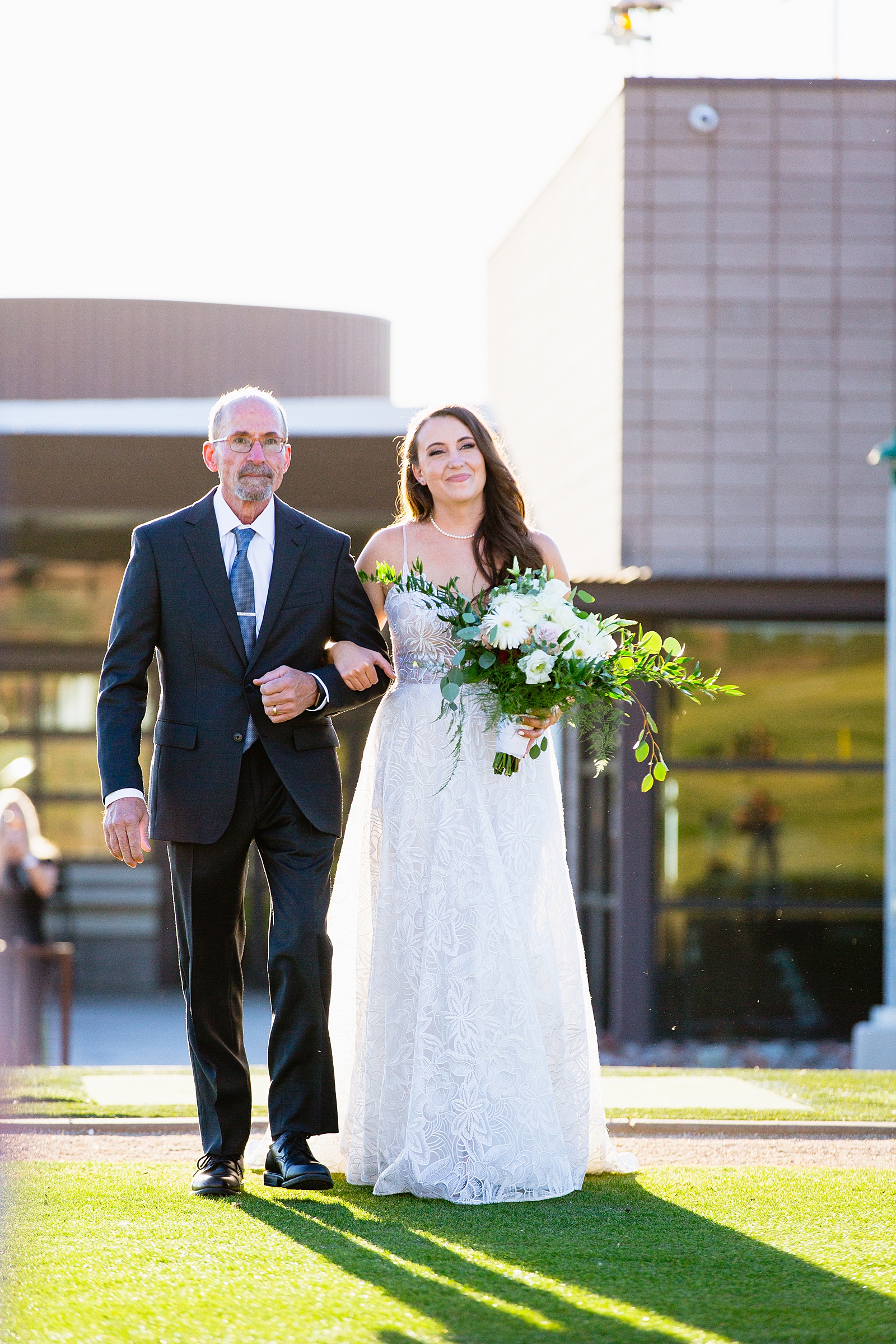 Bride walking down aisle during Papago Events wedding ceremony by Phoenix wedding photographer PMA Photography.