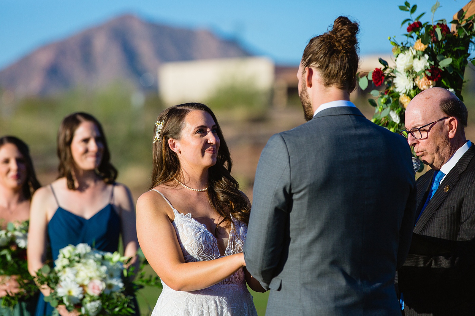 Bride looking at her groom during their wedding ceremony at Papago Events by Phoenix wedding photographer PMA Photography.