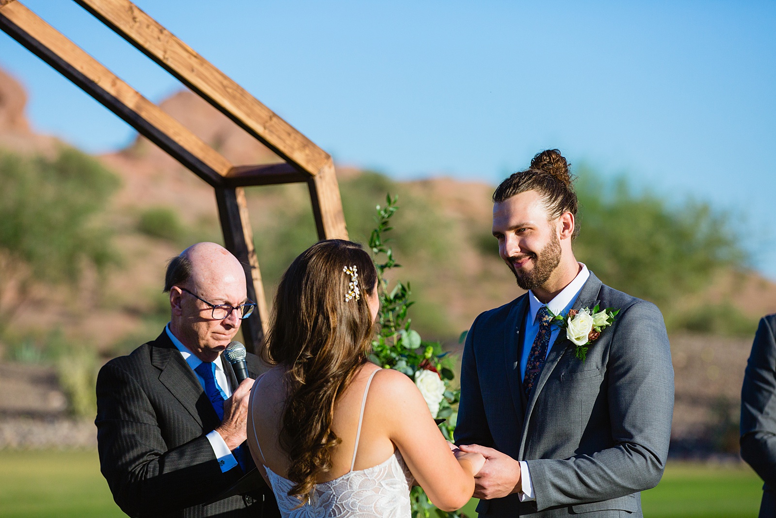 Groom looking at his bride during their wedding ceremony at Papago Events by Phoenix wedding photographer PMA Photography.
