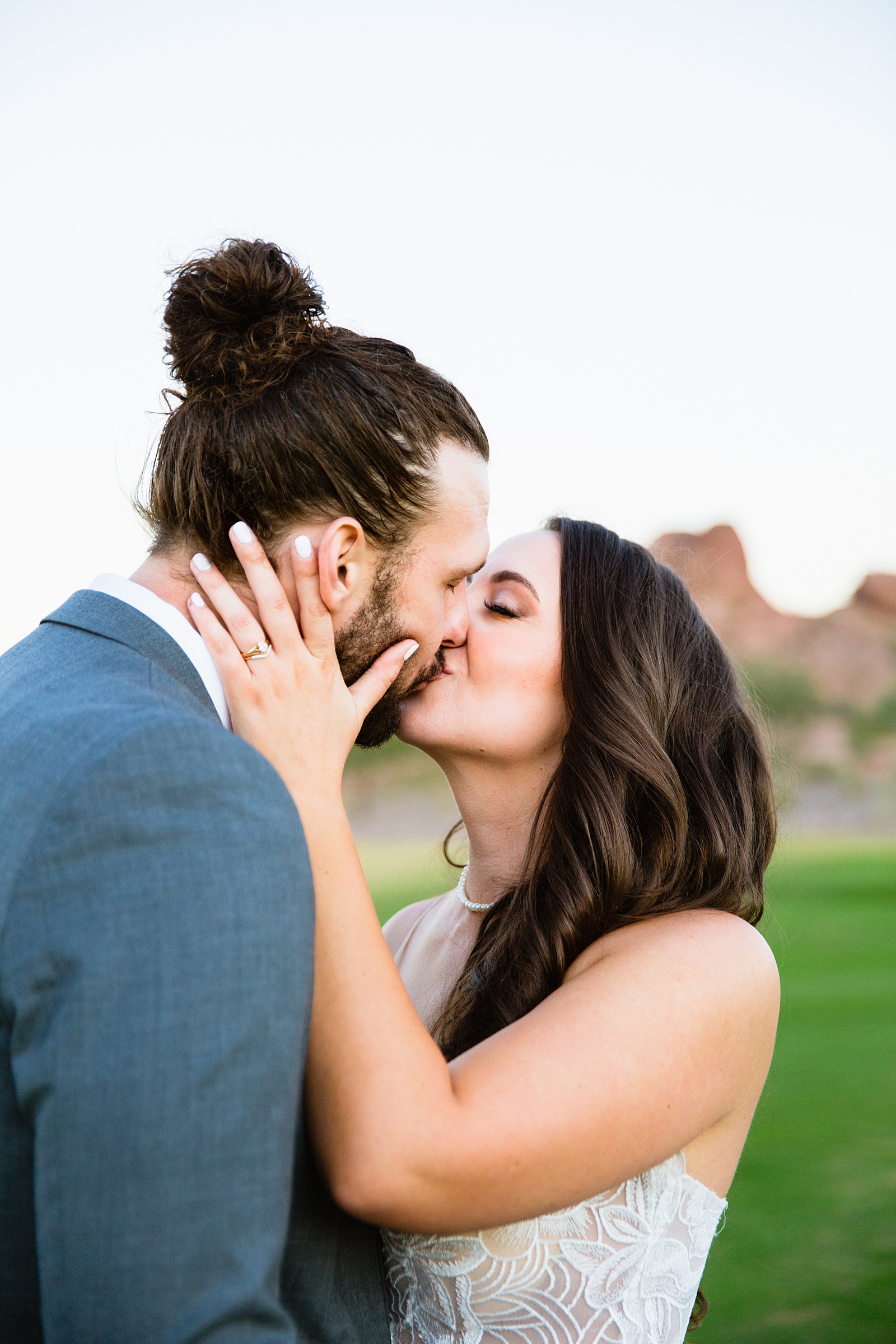 Bride and groom share a kiss during their Papago Events wedding by Arizona wedding photographer PMA Photography.