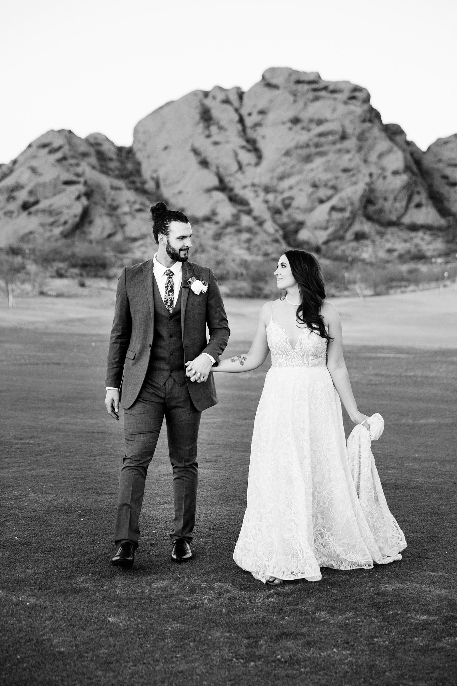 Bride and groom walking together during their Papago Events wedding by Phoenix wedding photographer PMA Photography.