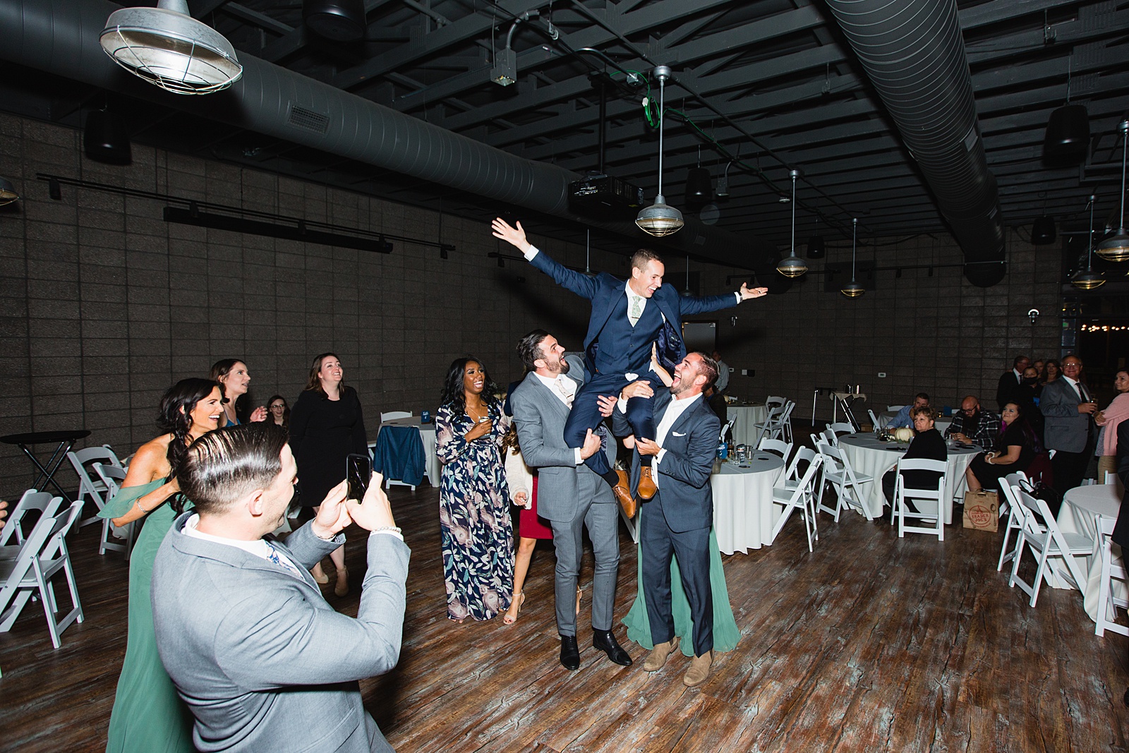 Guests dancing together at Papago Events wedding reception by Phoenix wedding photographer PMA Photography