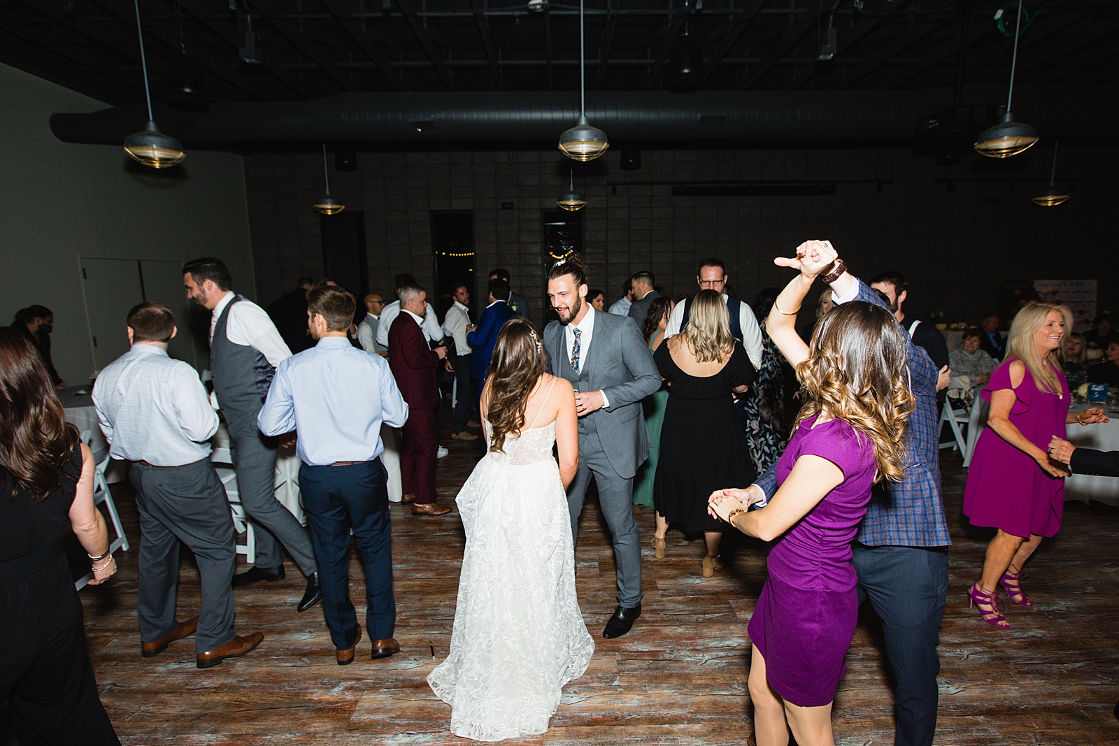 Bride and groom dancing with guests at their Papago Events wedding reception by Arizona wedding photographer PMA Photography