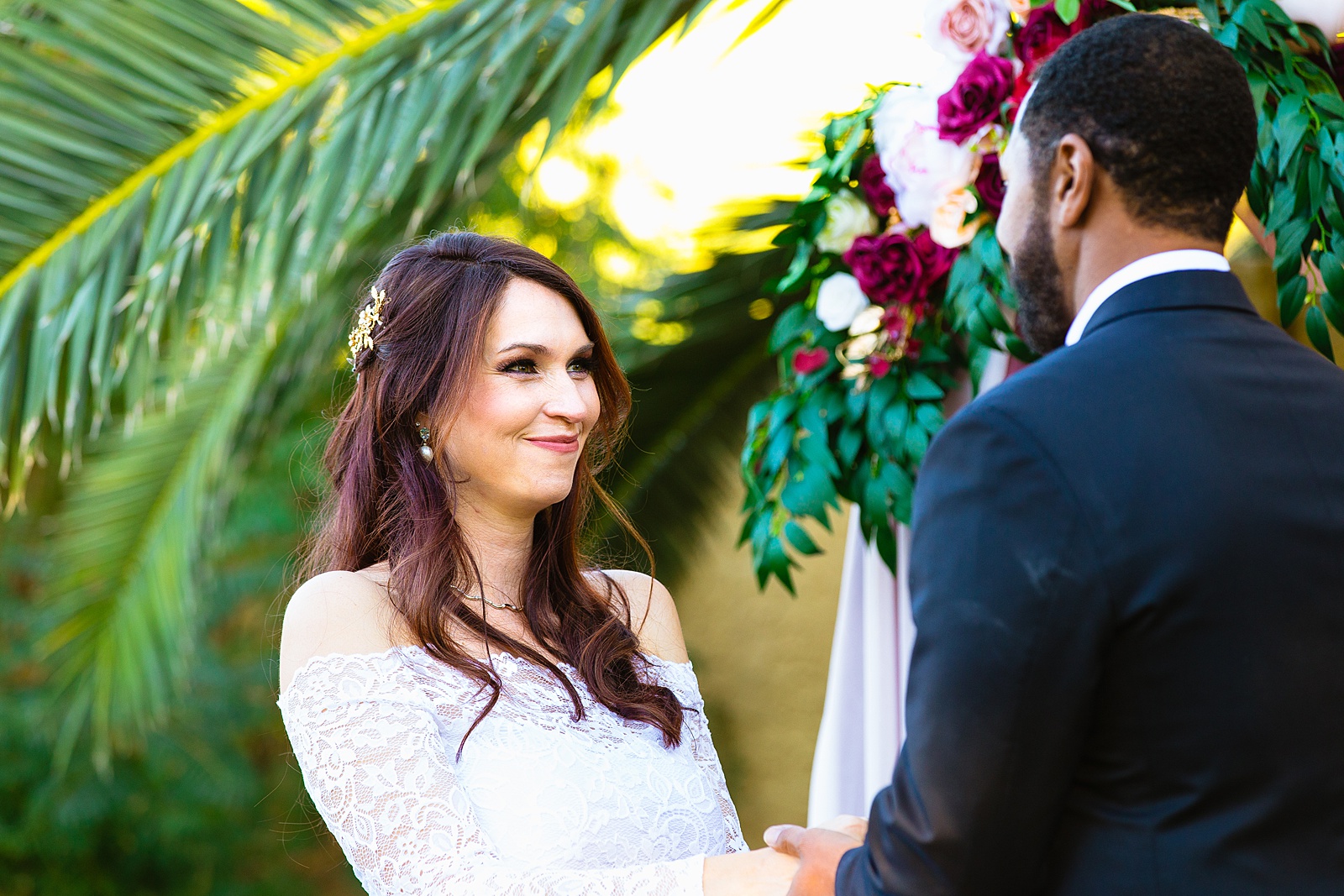 Bride looking at her groom during their wedding ceremony at Backyard Micro by Scottsdale wedding photographer PMA Photography.