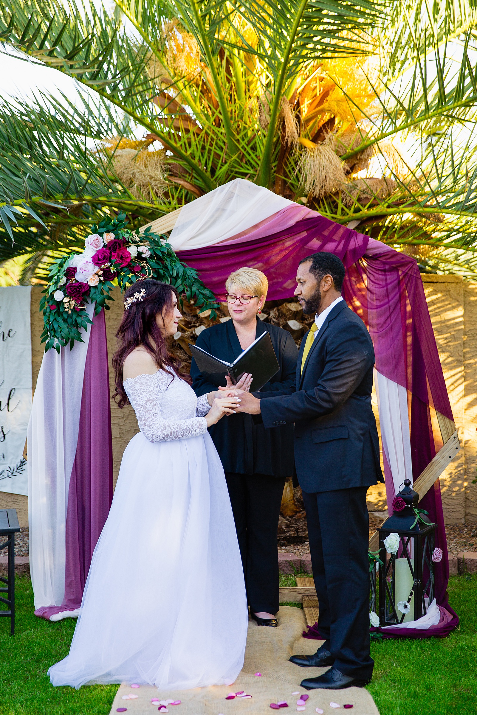 Bride and groom exchange rings during their wedding ceremony at Backyard Micro by Phoenix wedding photographer PMA Photography.