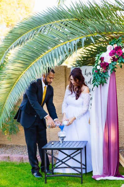 Bride and groom do a sand pouring ceremony for their wedding unity ceremony by Scottsdale Micro Wedding Photographer PMA Photography.
